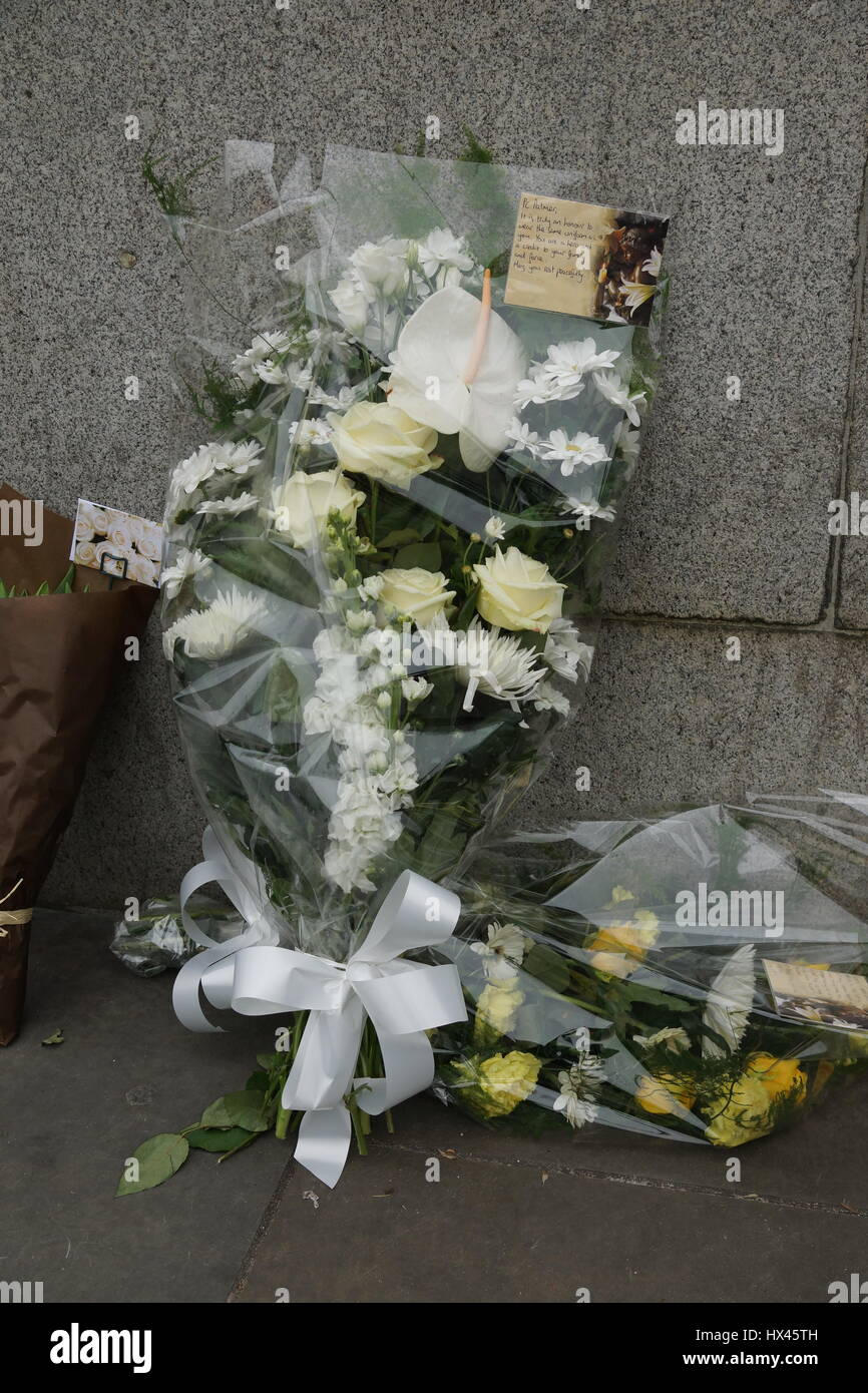 London, UK. 23rd Mar, 2017. Floral tribute. The scene outside the Houses of Parliament in the wake of the murder of PC Keith Palmer by Khalid Massood, also known as Adrian Elms, also known as Adrian Russell Ajao on Wednesday 21 March 2017. Members of the public pay floral tribute whilst television journalists make their reports and police officers survey the scene. Credit: Peter Hogan/Alamy Live News Stock Photo