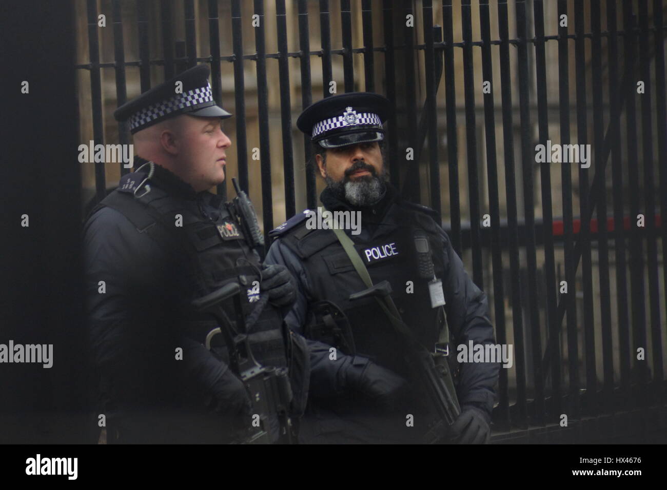 London, UK. 23rd Mar, 2017. Armed police at the scene.The scene outside the Houses of Parliament in the wake of the murder of PC Keith Palmer by Khalid Massood, also known as Adrian Elms, also known as Adrian Russell Ajao on Wednesday 21 March 2017. Members of the public pay floral tribute whilst television journalists make their reports and police officers survey the scene. Credit: Peter Hogan/Alamy Live News Stock Photo