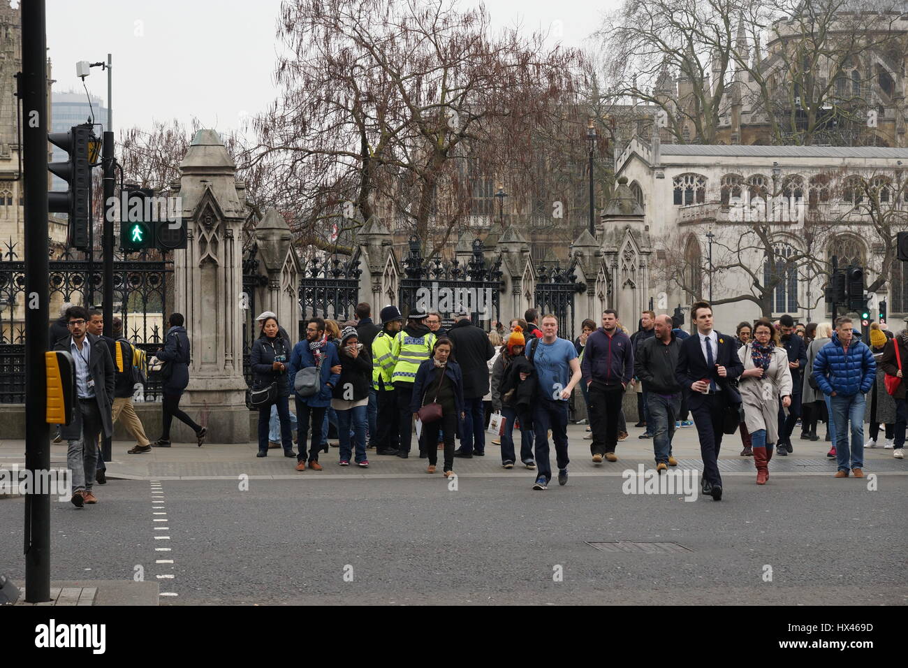 London, UK. 23rd Mar, 2017. The scene outside the Houses of Parliament in the wake of the murder of PC Keith Palmer by Khalid Massood, also known as Adrian Elms, also known as Adrian Russell Ajao on Wednesday 21 March 2017. Members of the public pay floral tribute whilst television journalists make their reports and police officers survey the scene. Credit: Peter Hogan/Alamy Live News Stock Photo