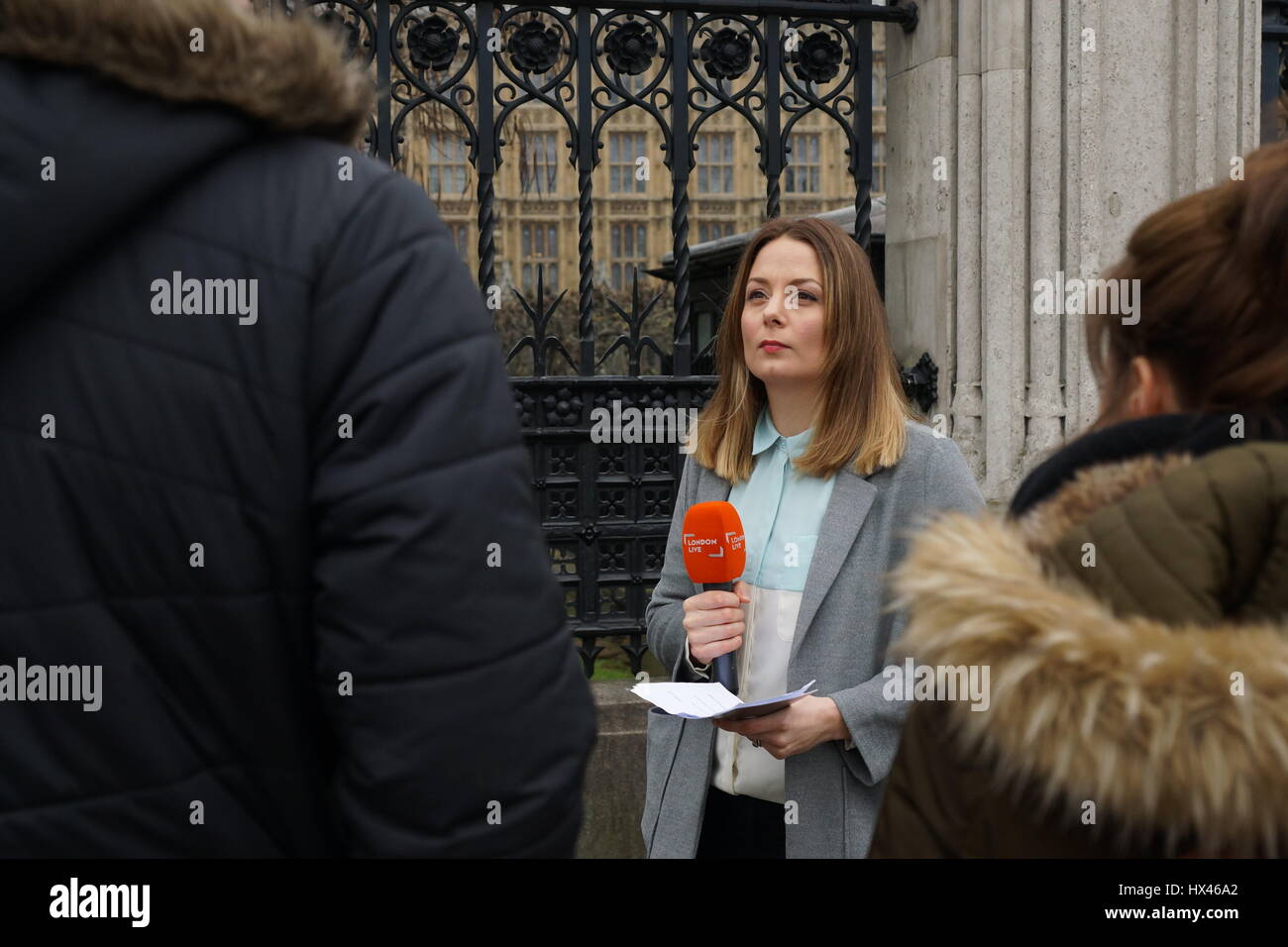 London, UK. 23rd Mar, 2017. Television journalist reports from the scene outside the Houses of Parliament in the wake of the murder of PC Keith Palmer by Khalid Massood, also known as Adrian Elms, also known as Adrian Russell Ajao on Wednesday 21 March 2017. Members of the public pay floral tribute whilst television journalists make their reports and police officers survey the scene. Credit: Peter Hogan/Alamy Live News Stock Photo