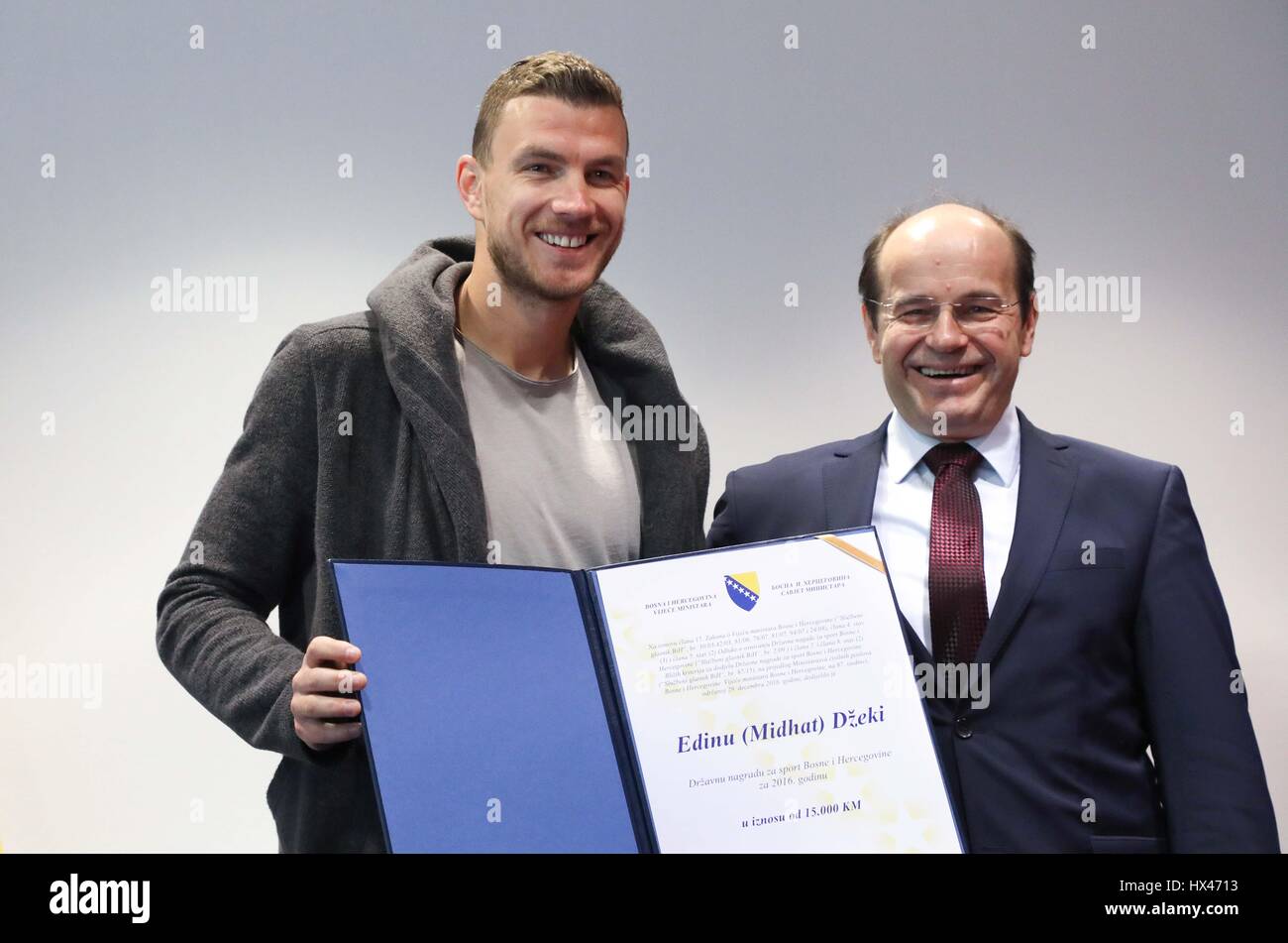 Sarajevo, BiH. 24th Mar, 2017. The captain of the football team of Bosnia and Herzegovina (BiH) and AS Roma's striker Edin Dzeko (L) and the Minister of Civil Affairs of BiH Adil Osmanovic pose for a photo in Sarajevo, BiH, March 24, 2017. The Ministry of Civil Affairs of BiH awarded Edin Dzeko with the State Award for Sports in 2016 on Friday. Credit: Haris Memija/Xinhua/Alamy Live News Stock Photo
