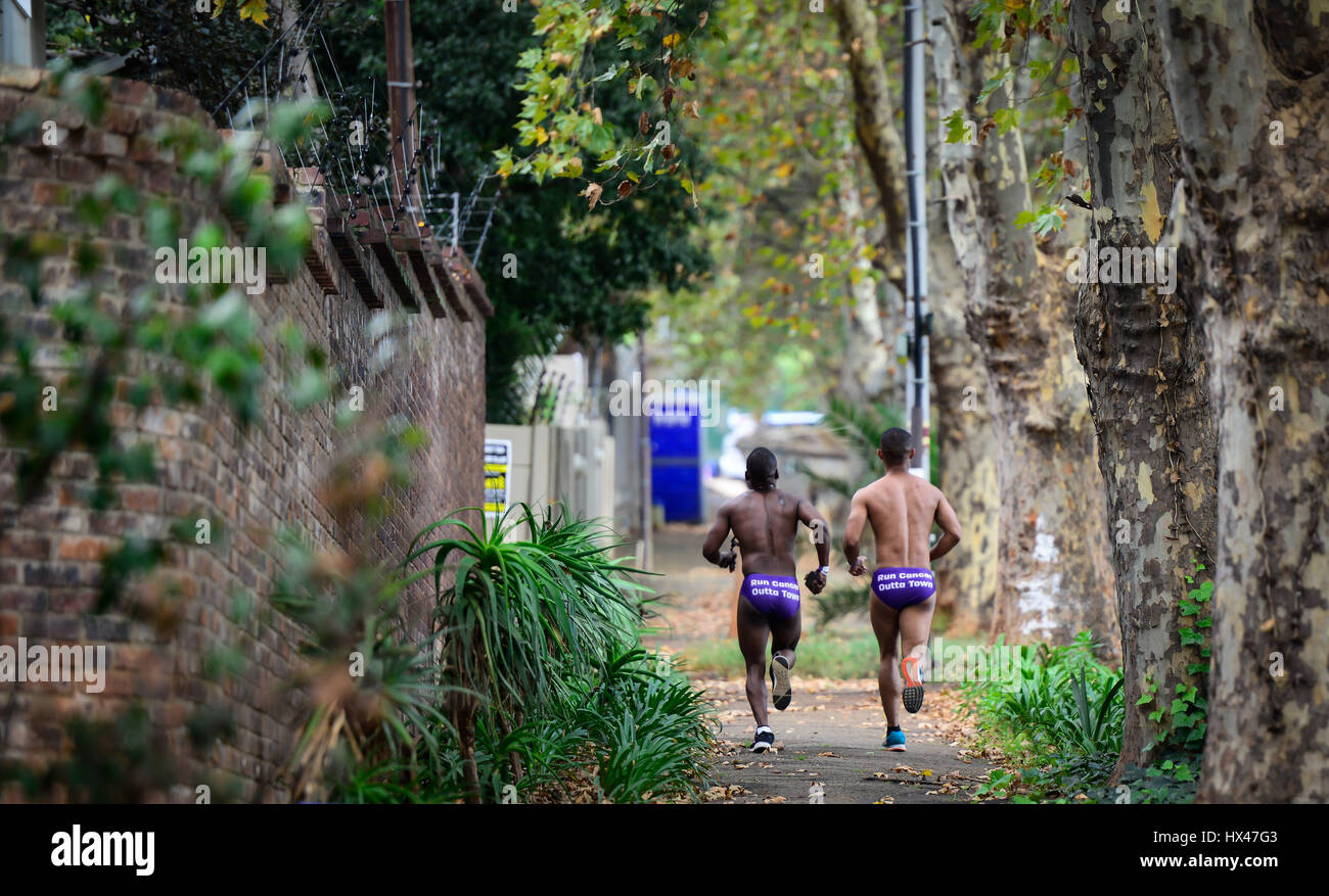 Johannesburg, South Africa. 24th Mar, 2017. Two runners participate in