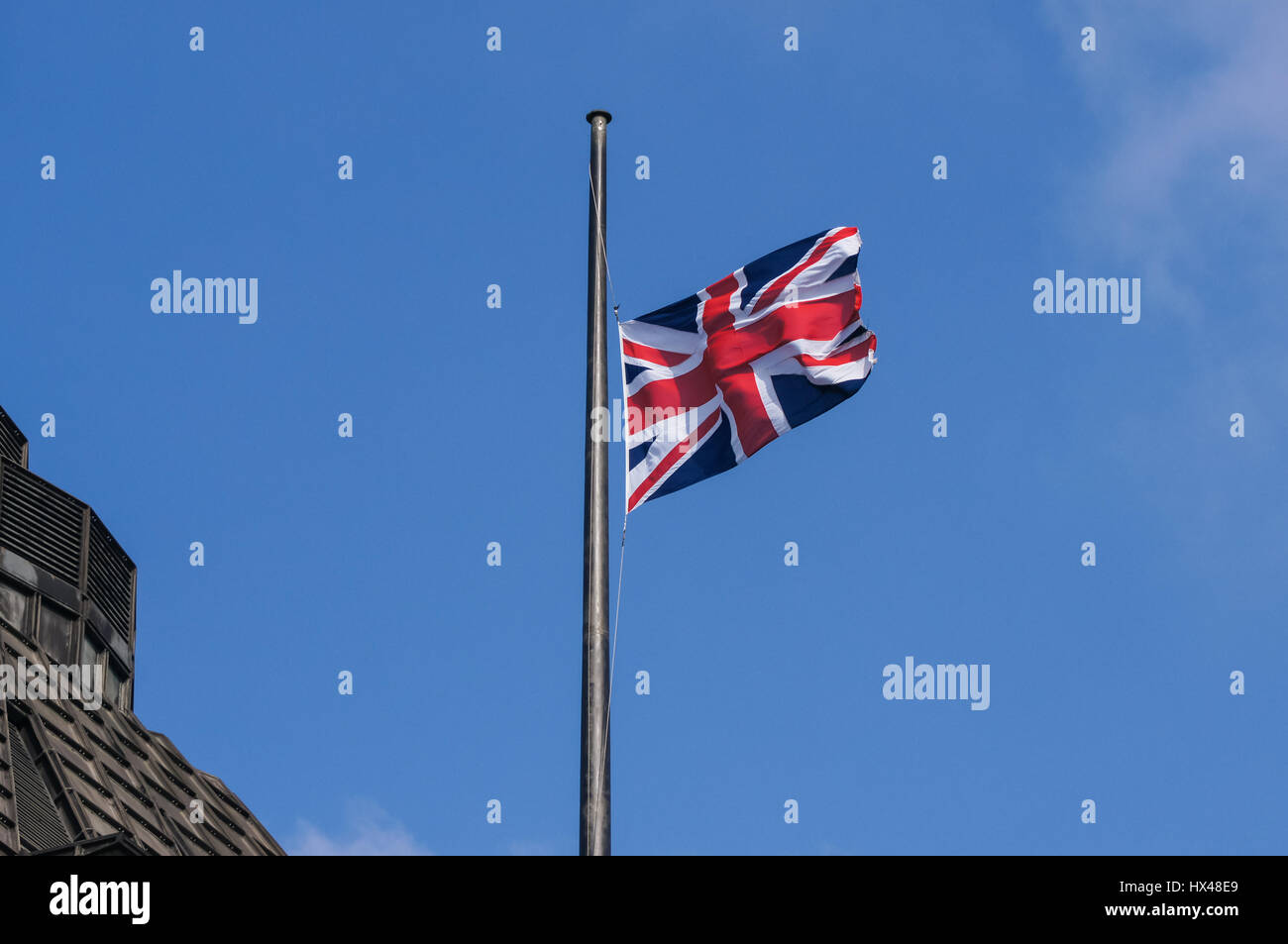 London, UK. 24th March, 2017. Union Jack flag at half mast on the Portcullis House after the terrorist attack. Credit: Marcin Rogozinski/Alamy Live News Stock Photo