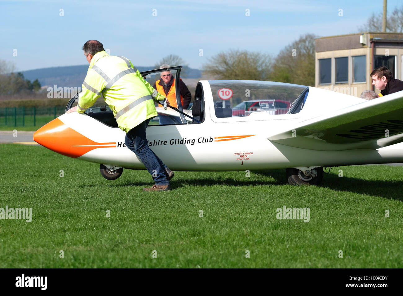 UK Weather - Saturday 25th March 2017 -  Shobdon airfield, Herefordshire - Perfect Spring day to go flying with blue skies and temperatures up to 15c locally. Members of the Herefordshire Gliding Club prepare their two seater training glider for another flight on a weekend of high presure and sunny weather.  Photo Steven May / Alamy Live News Stock Photo