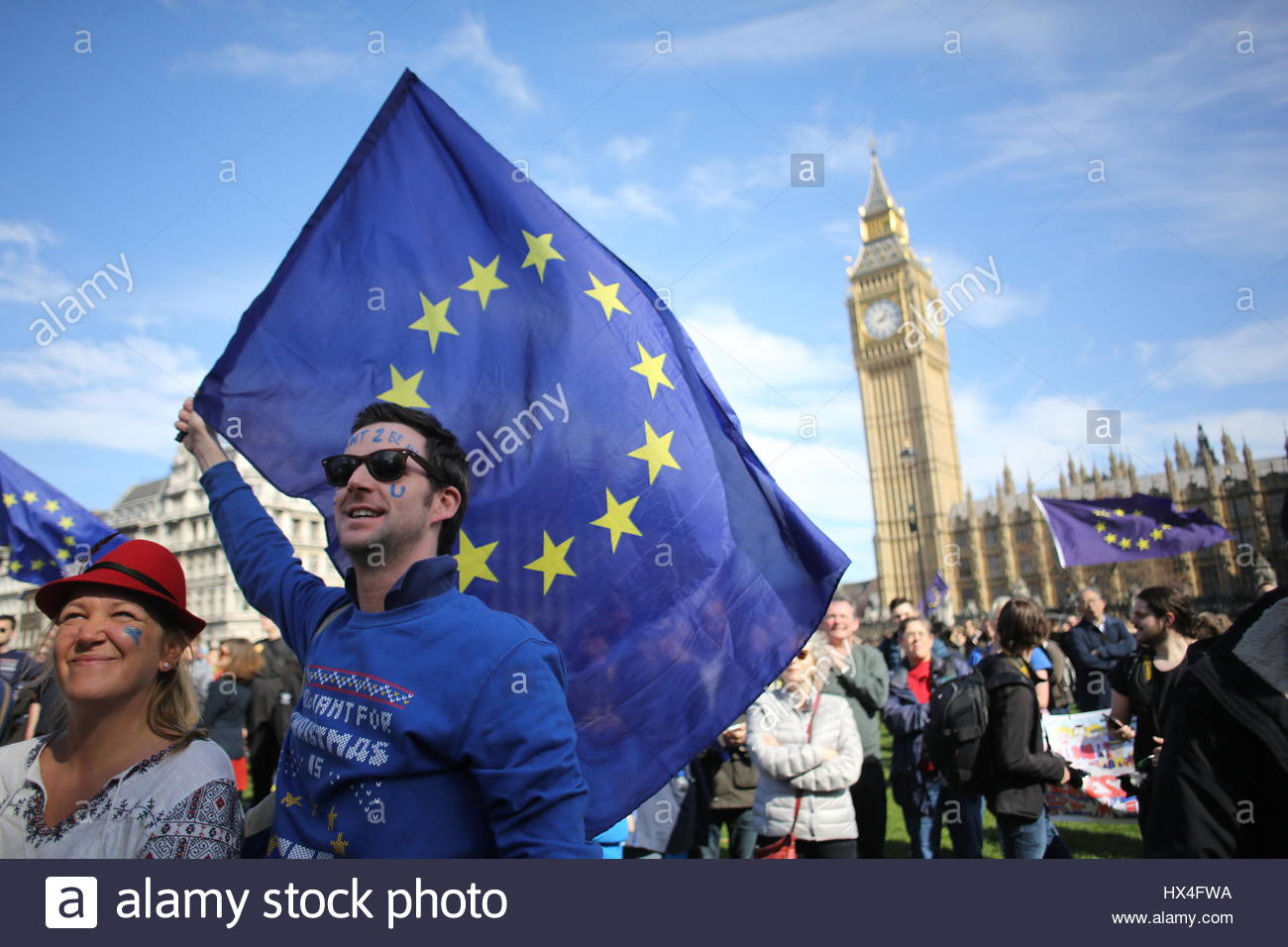 a-protestor-waves-a-pro-eu-flag-at-an-anti-brexit-rally-HX4FWA.jpg