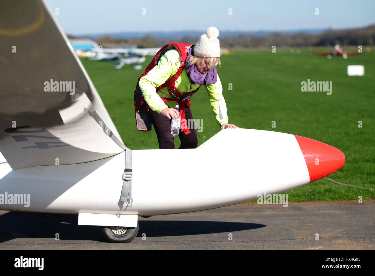 Shobdon airfield,  Busy day at Herefordshire Gliding Club on a day of perfect spring weather. A female glider pilot gets ready to fly her single seat Standard Libelle glider. Stock Photo