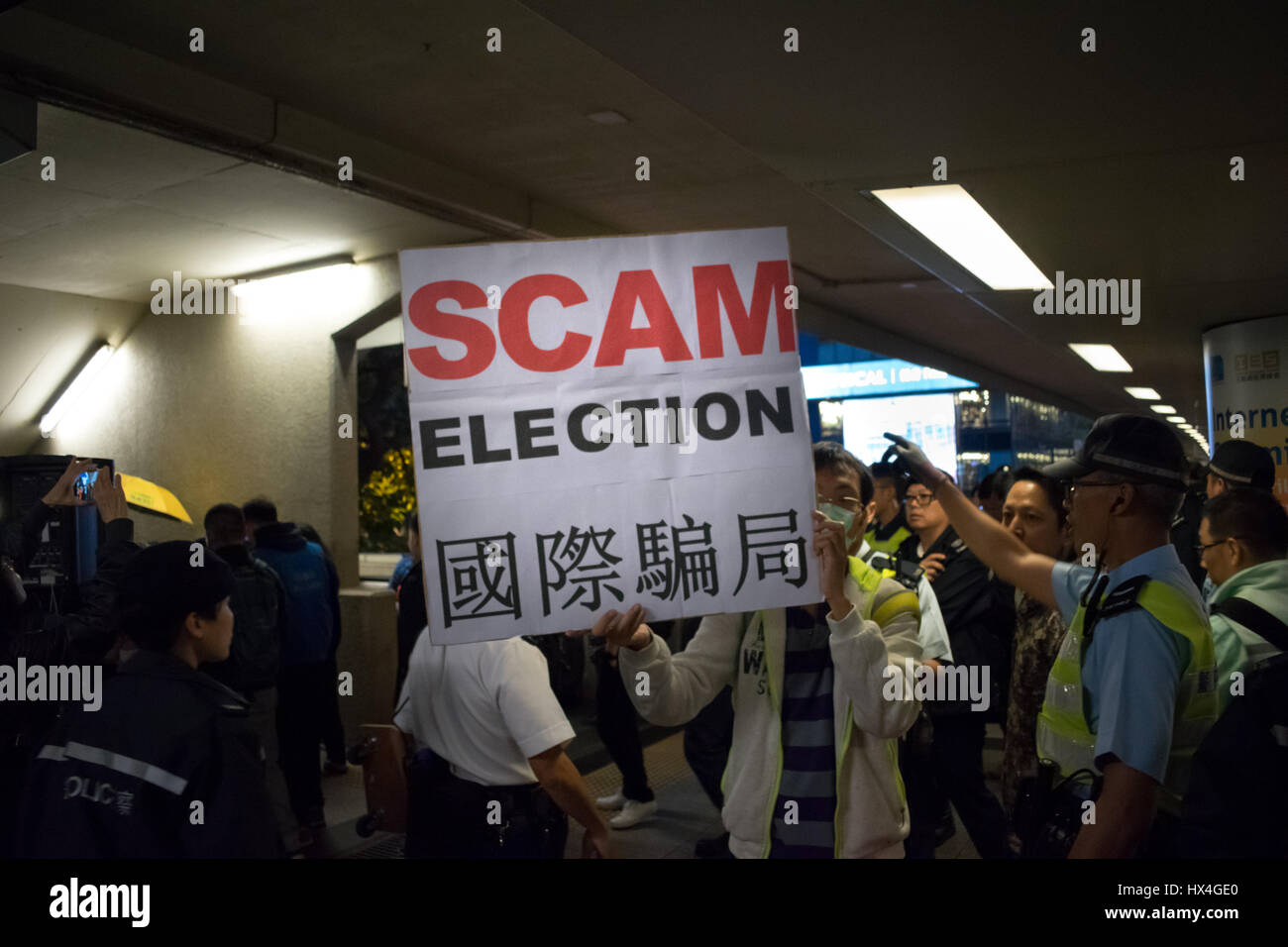 Hong Kong SAR, China. 25th March, 2017. Protester showing a message during pro-democracy demonstration, amid strong police presence, as Hong Kong votes for a new Chief Executive (city's leader) in Hong Kong, China. © RaymondAsiaPhotography / Alamy Live News. Stock Photo
