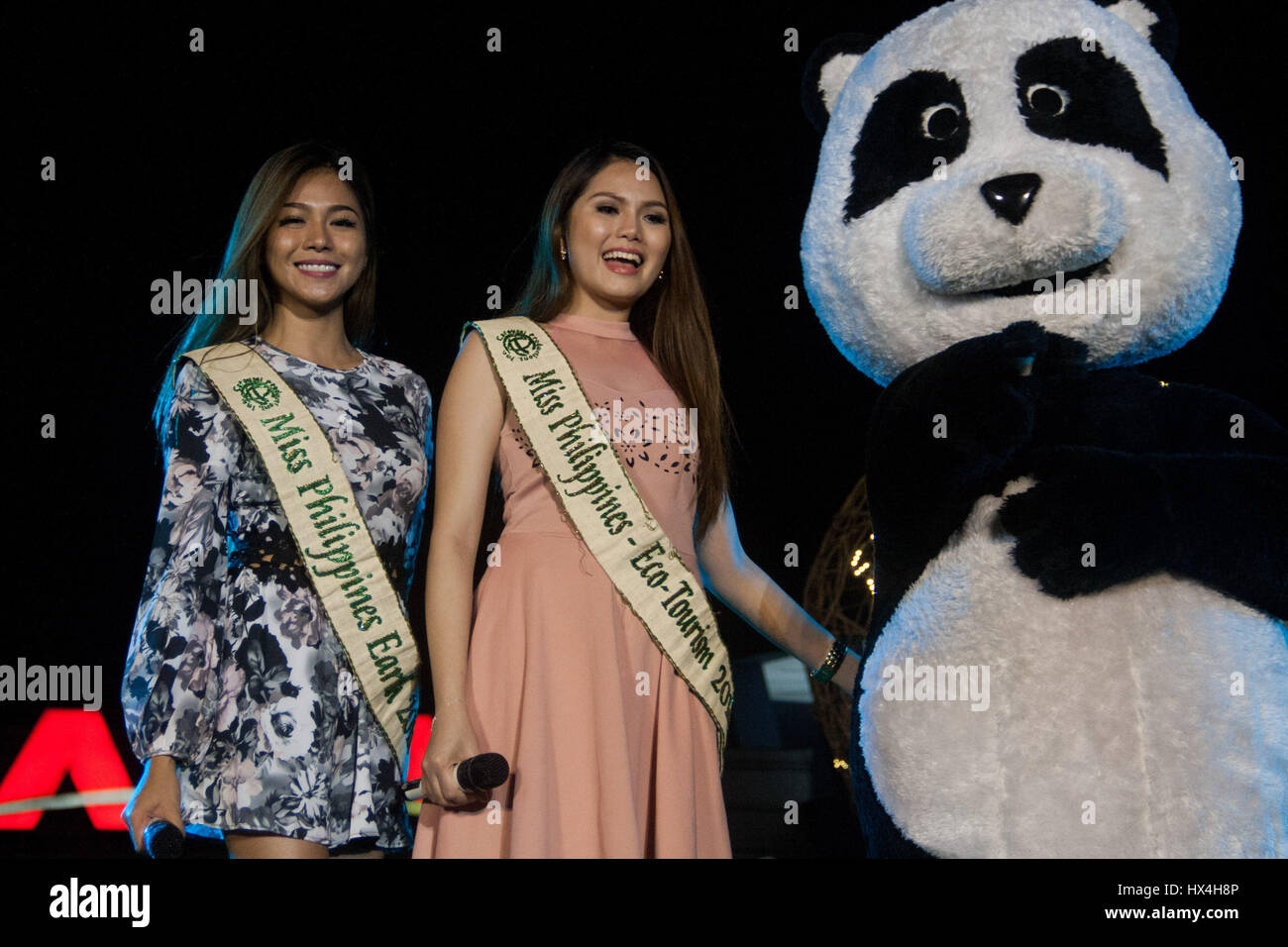 Philippines. 25th Mar, 2017. Miss Earth philippines 2016 Loren Mar Artajos (L) and Miss Philippines Eco-Tourism 2016 Charinna Gamaya Barro with Chi-chi the panda at the Mall of Asia for the 2017 Earth Hour event. The 10th year anniversary of the one hour switch off was held at the Mall of Asia, SM by the Bay, with participants from different environmental groups lead by the World Wildlife Fund. Credit: J Gerard Seguia/ZUMA Wire/Alamy Live News Stock Photo