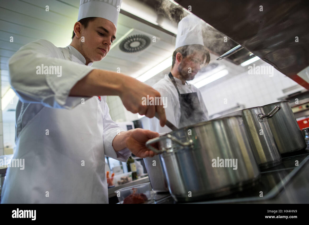 Stralsund, Germany. 21st Mar, 2017. Trainee cooks Johannes Volckmann (L) and Lorenz Maash (R) at the stove during a competition for up and coming chefs in German state of Mecklenburg-Western Pomerania, in Stralsund, Germany, 21 March 2017. In total 27 trainees from the three local Chamber of Commerce districts qualified for the competition. Photo: Jens Büttner/dpa-Zentralbild/dpa/Alamy Live News Stock Photo