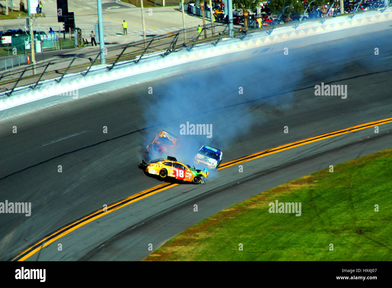 Kyle Busch collects three other drivers in a wreck off of turn 4 at Daytona International Speedway during the 2017 Daytona 500. Stock Photo