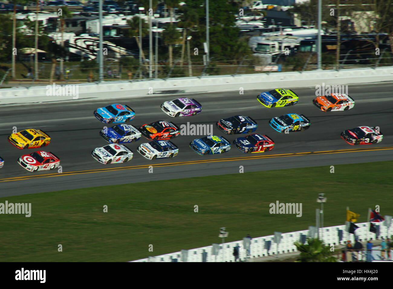 NASCAR race cars three wide on Daytona International Speedway's turn 4 during the 2017 Daytona 500. Stock Photo