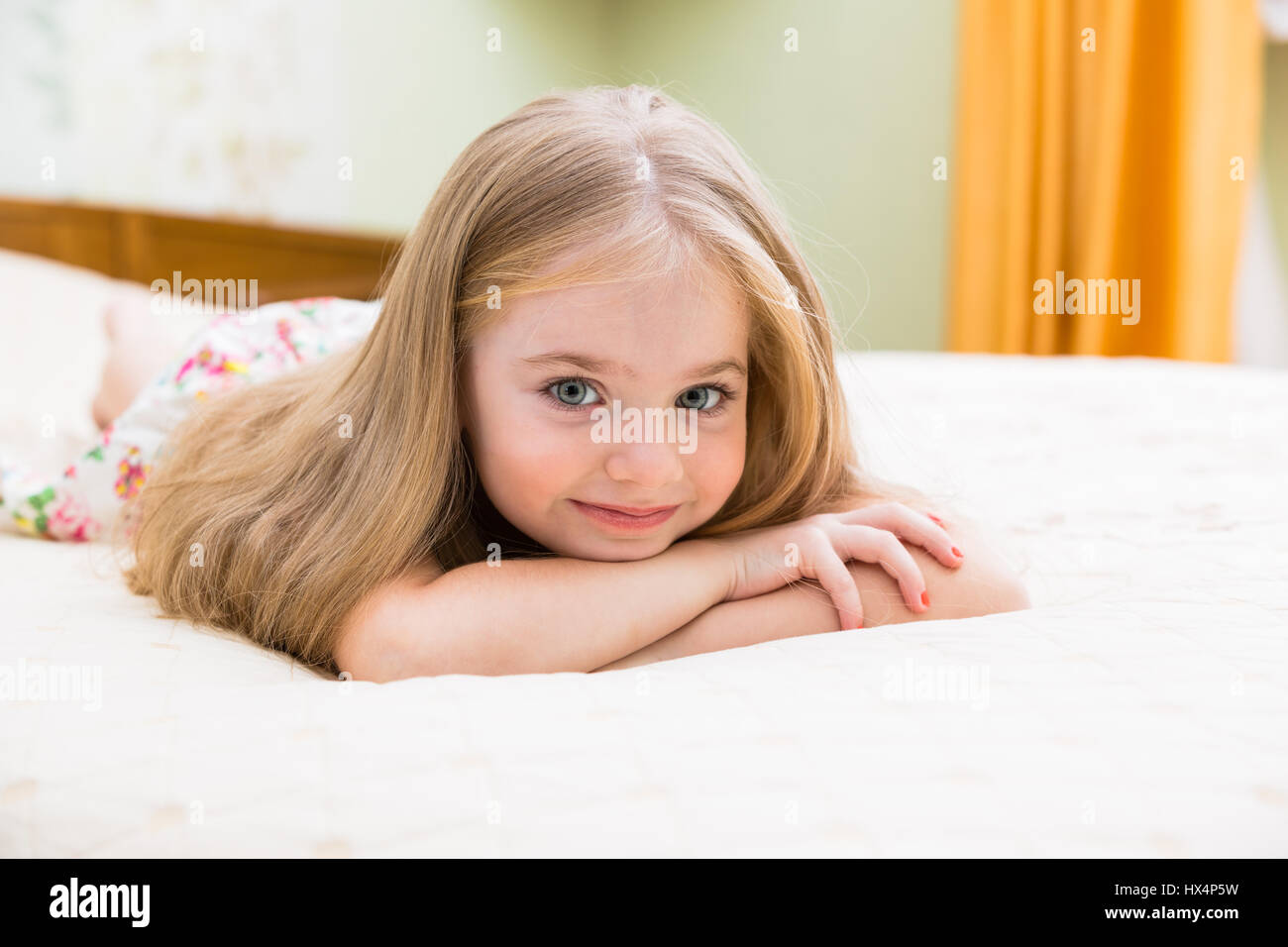 Adorable little girl awaked up in her bed Stock Photo - Alamy