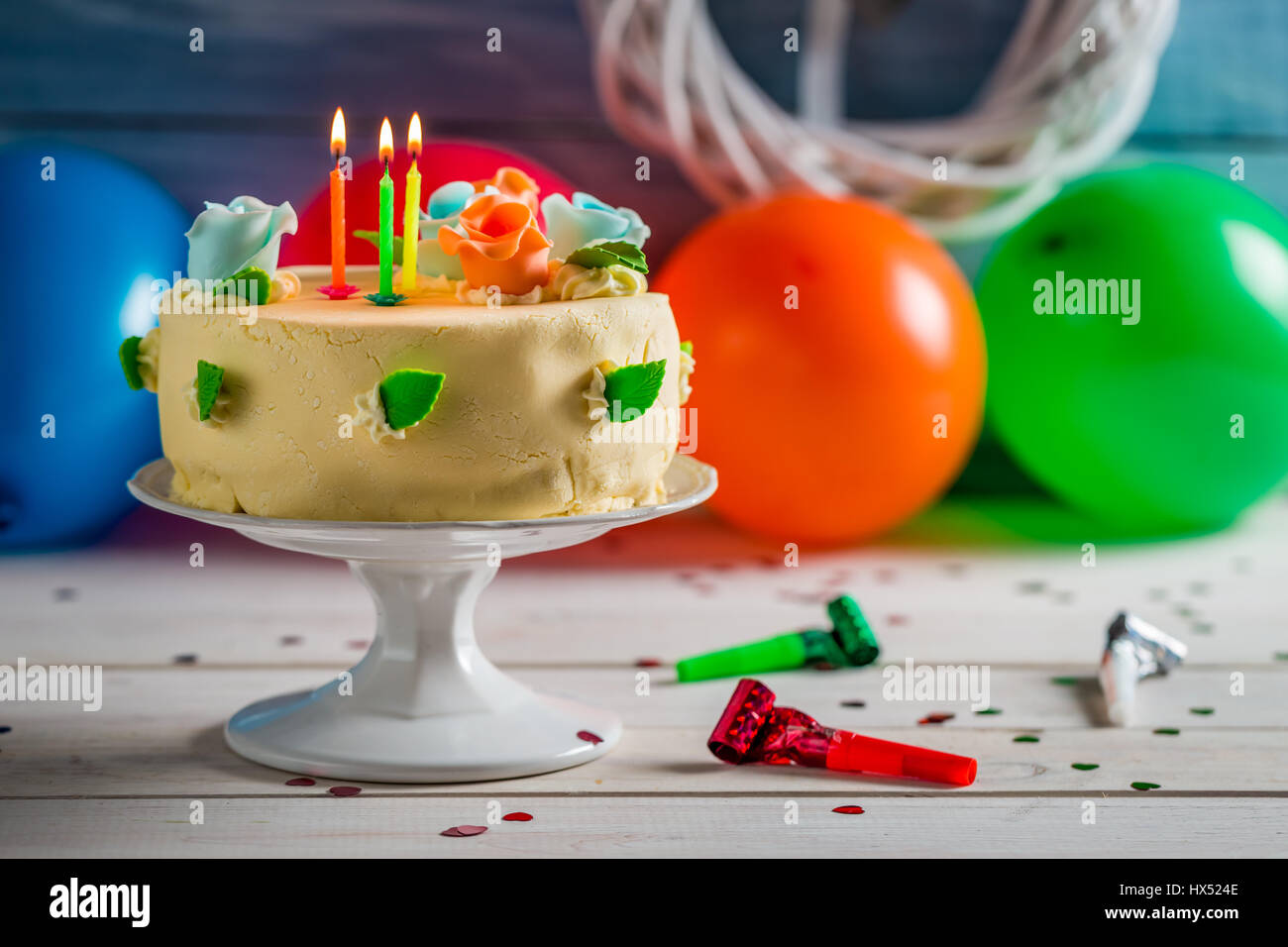 Lighted candles on birthday cake on old wooden table Stock Photo - Alamy