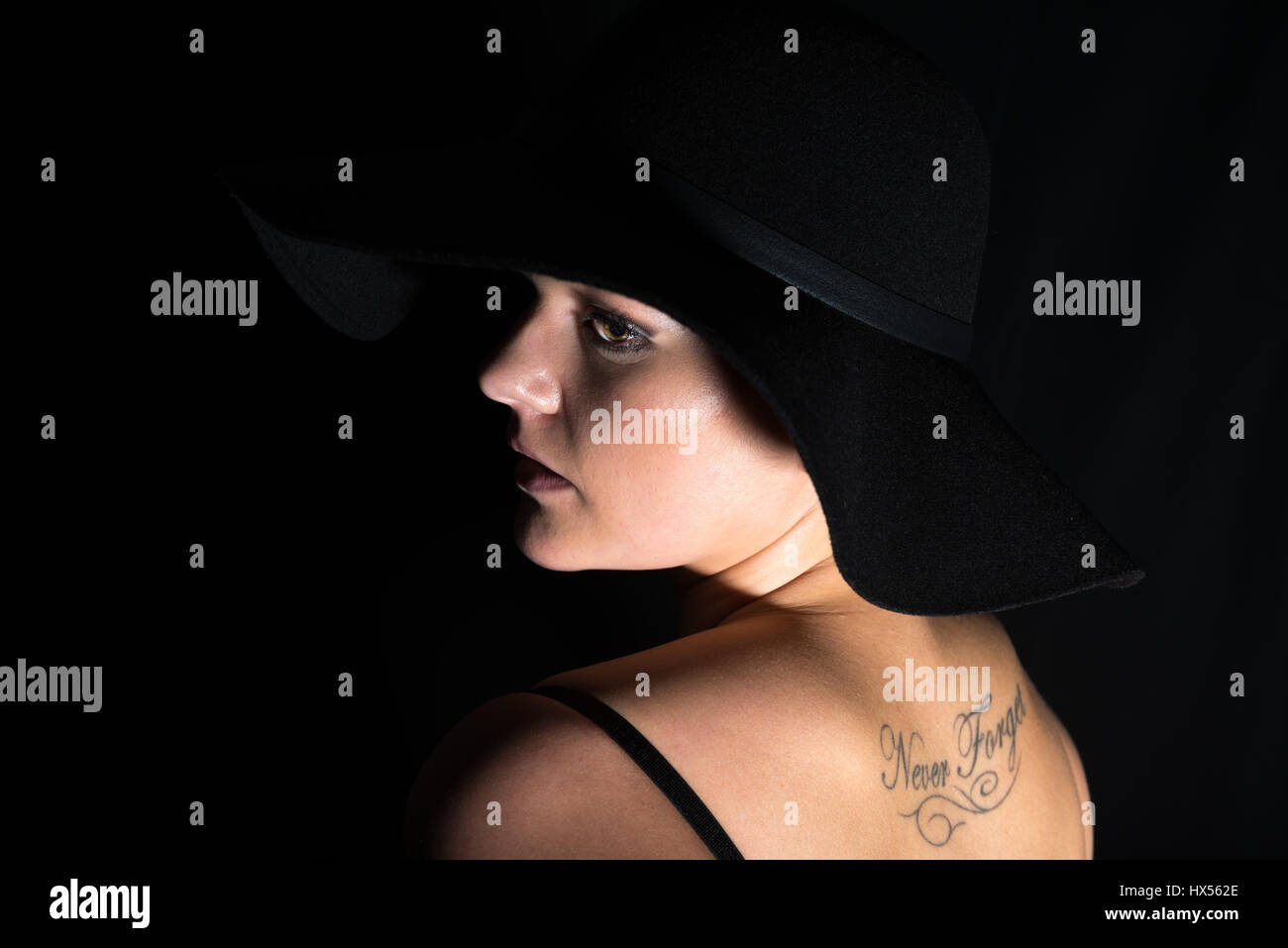 Young woman with a black hat Stock Photo