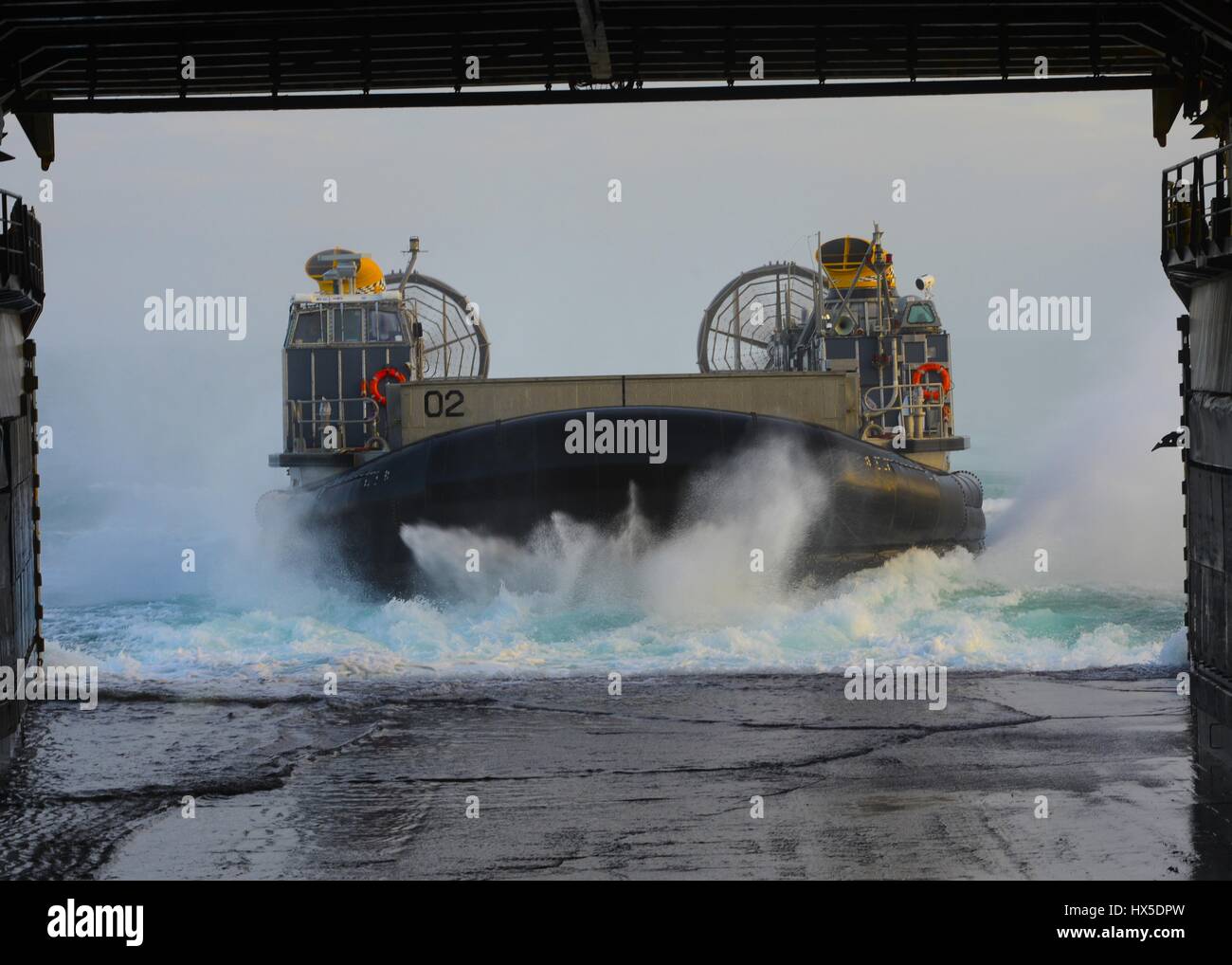 A landing craft air cushion (LCAC) enters the well deck of amphibious dock landing ship USS Carter Hall (LSD 50), Atlantic Ocean, 2013. Image courtesy Chelsea Mandello/US Navy. Stock Photo