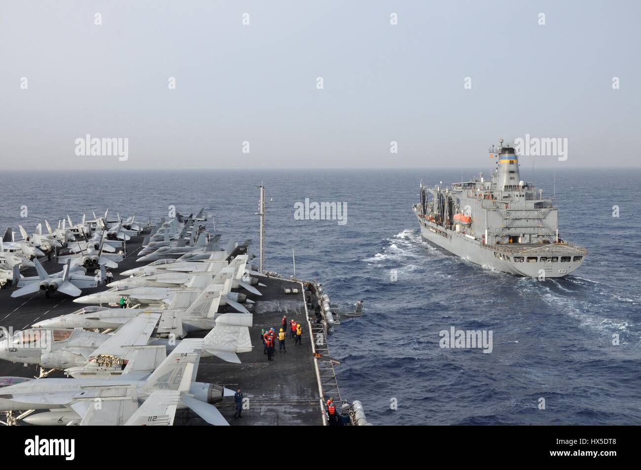 Aircraft carrier USS Dwight D. Eisenhower (CVN 69) and Military Sealift Command fleet replenishment oiler USNS Kanawha (T-AO 196) participate in a replenishment-at-sea, Mediterranean Sea, 2013. Image courtesy Rob Rupp/US Navy. Stock Photo
