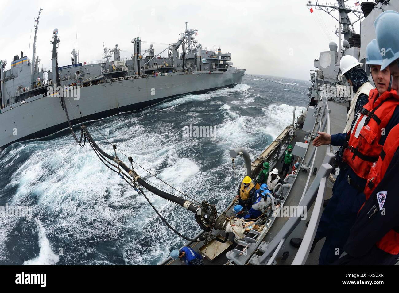 Military Sealift Command fast combat support ship USNS Rainier (T-AOE-7) and Arleigh Burke-class guided-missile destroyer USS McCampbell (DDG 85) during a replenishment-at-sea, west of the Korean Peninsula, 2013. Image courtesy Declan Barnes/Image courtesy US Navy. Stock Photo