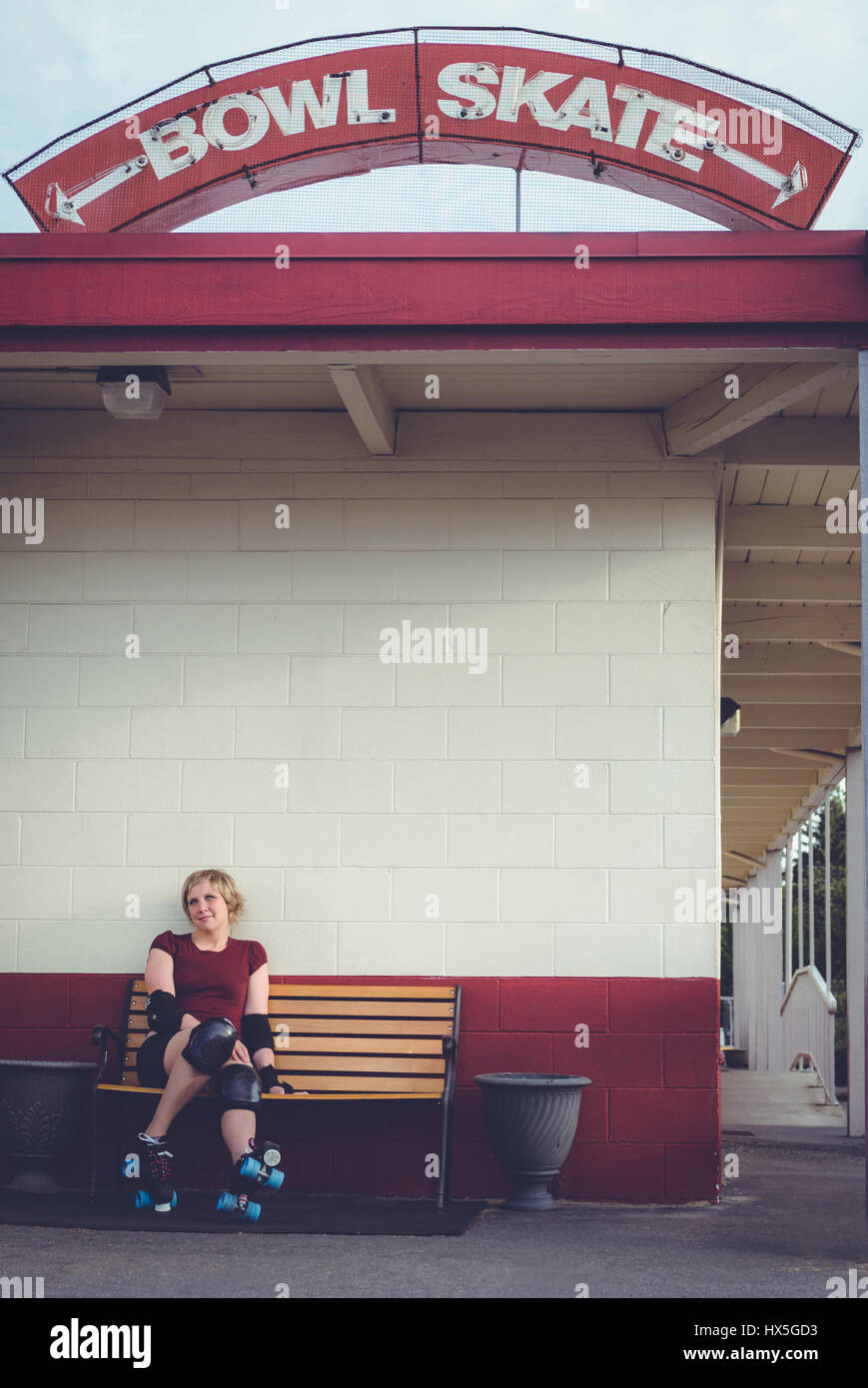 Woman on roller skates outside of a roller rink. Stock Photo