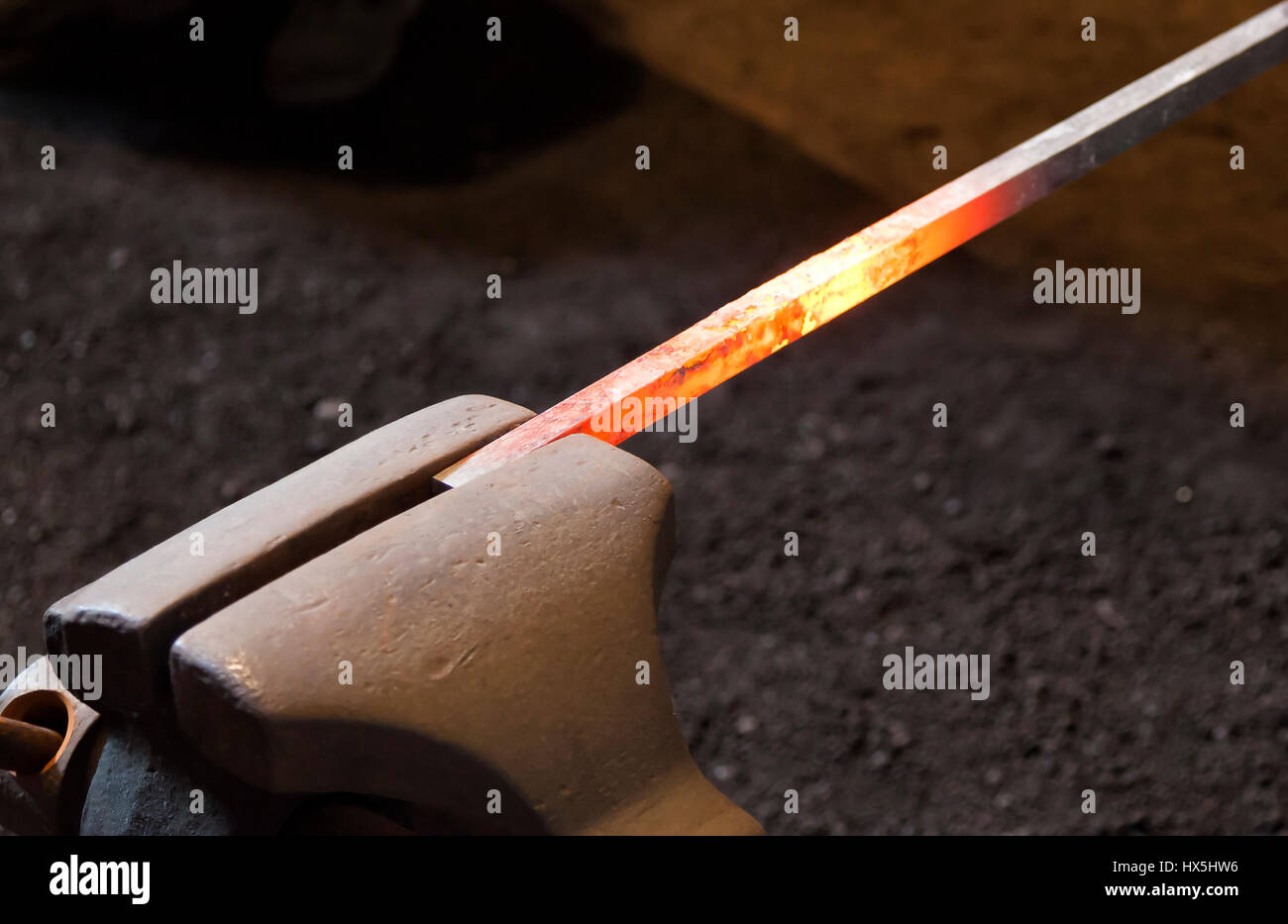 Red hot steel bar in a blacksmith's forgue Stock Photo