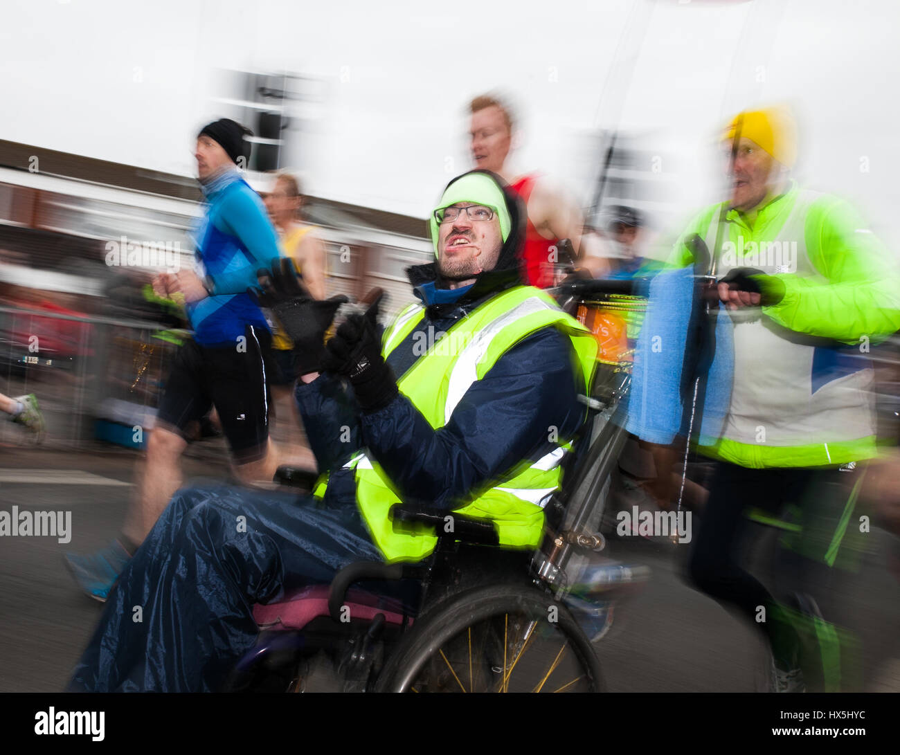 A man in a wheelchair takes part in The World Half Marathon, Cardiff, UK, 26th March 2016 Stock Photo