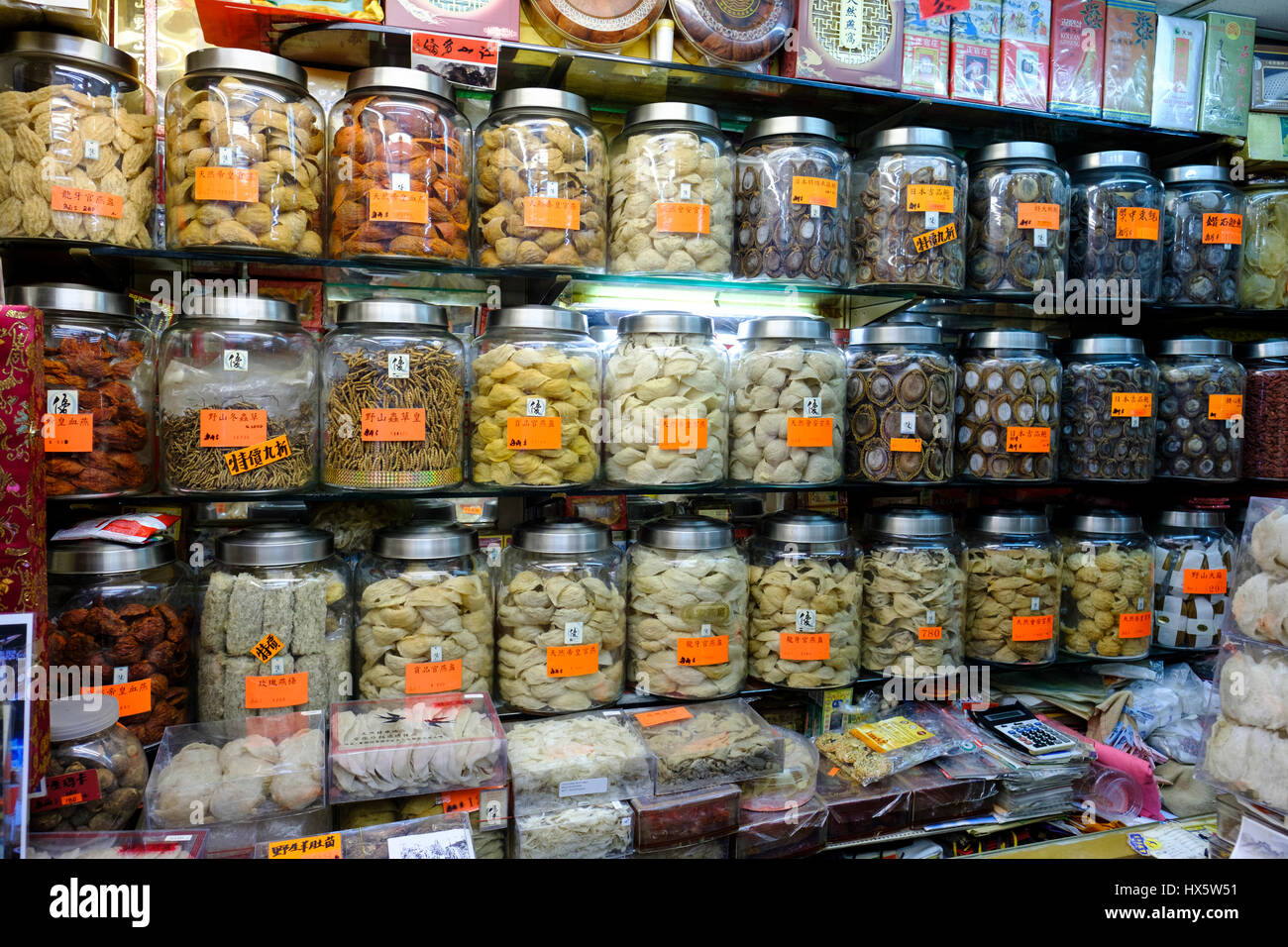 Shelves stacked with jars containing dried seafood, bird's nest and other traditional Chinese tonic foods, Hong Kong Island, China. Stock Photo