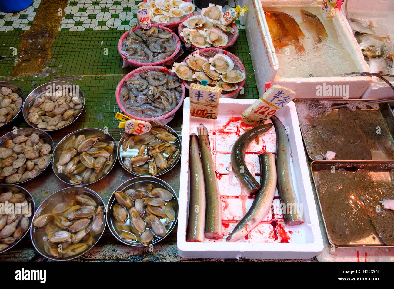 Fish and other seafood at a fishmonger's in Shau Kei Wan wet market, Hong Kong Island, Hong Kong, China. Stock Photo