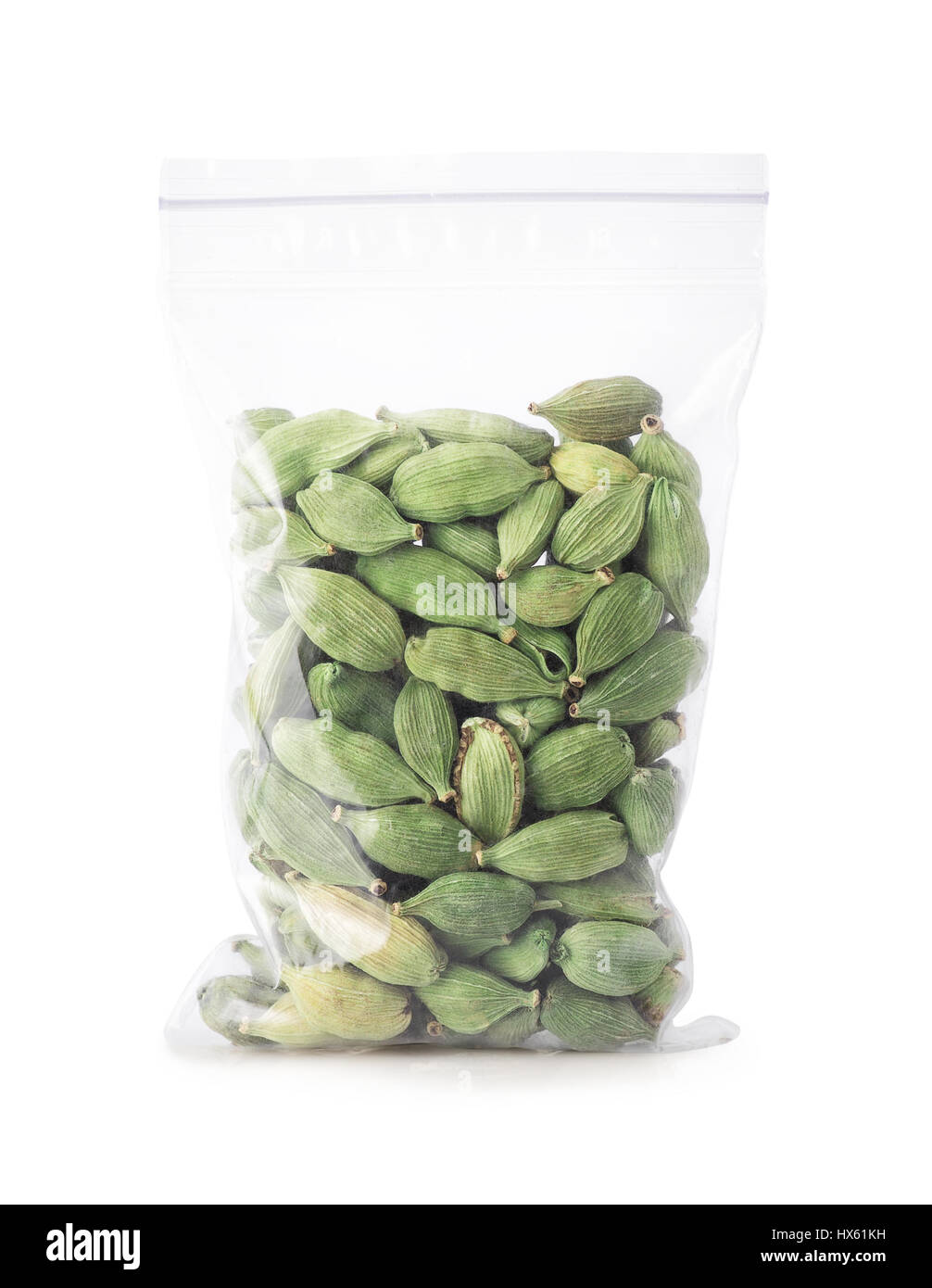 green cardamom seeds in plastic zipper bag isolated on white background. Cardamom pods in bag. Indian spice. Condiment Stock Photo