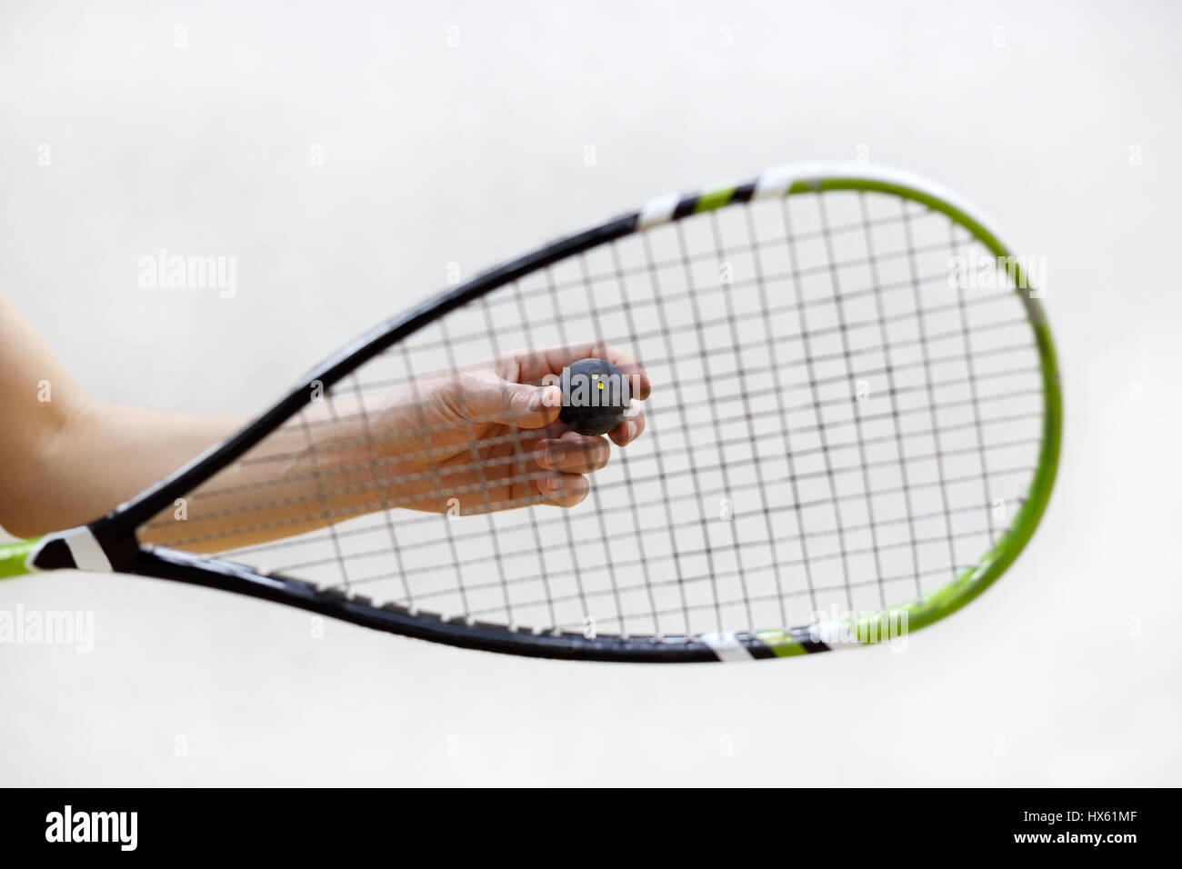 squash racket and ball in male hands. Racquetball equipment. Photo with selective focus. Player