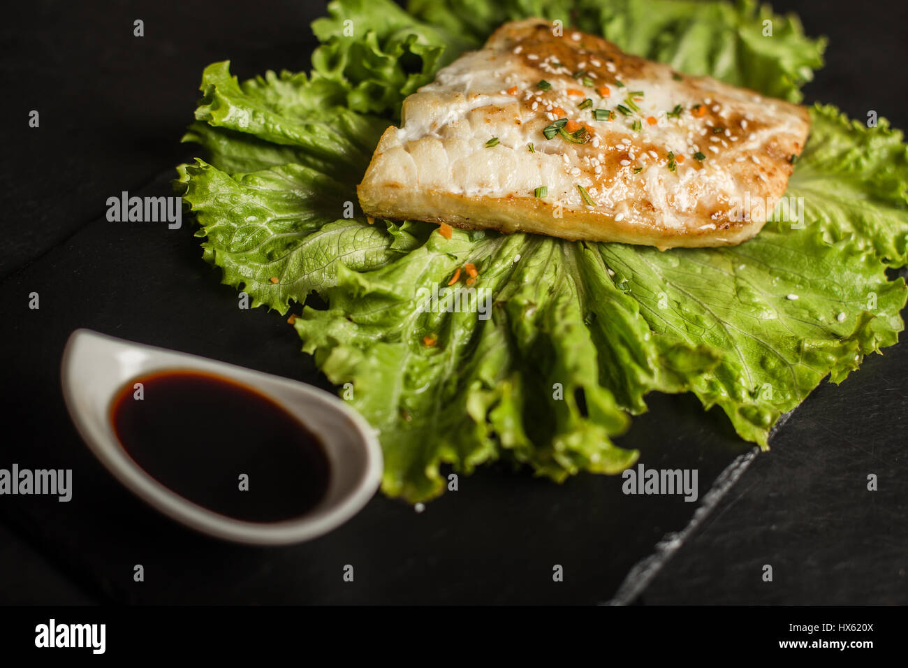 Grilled pangasius with sauce. Seafood. Fish dish. Restaurant Stock Photo