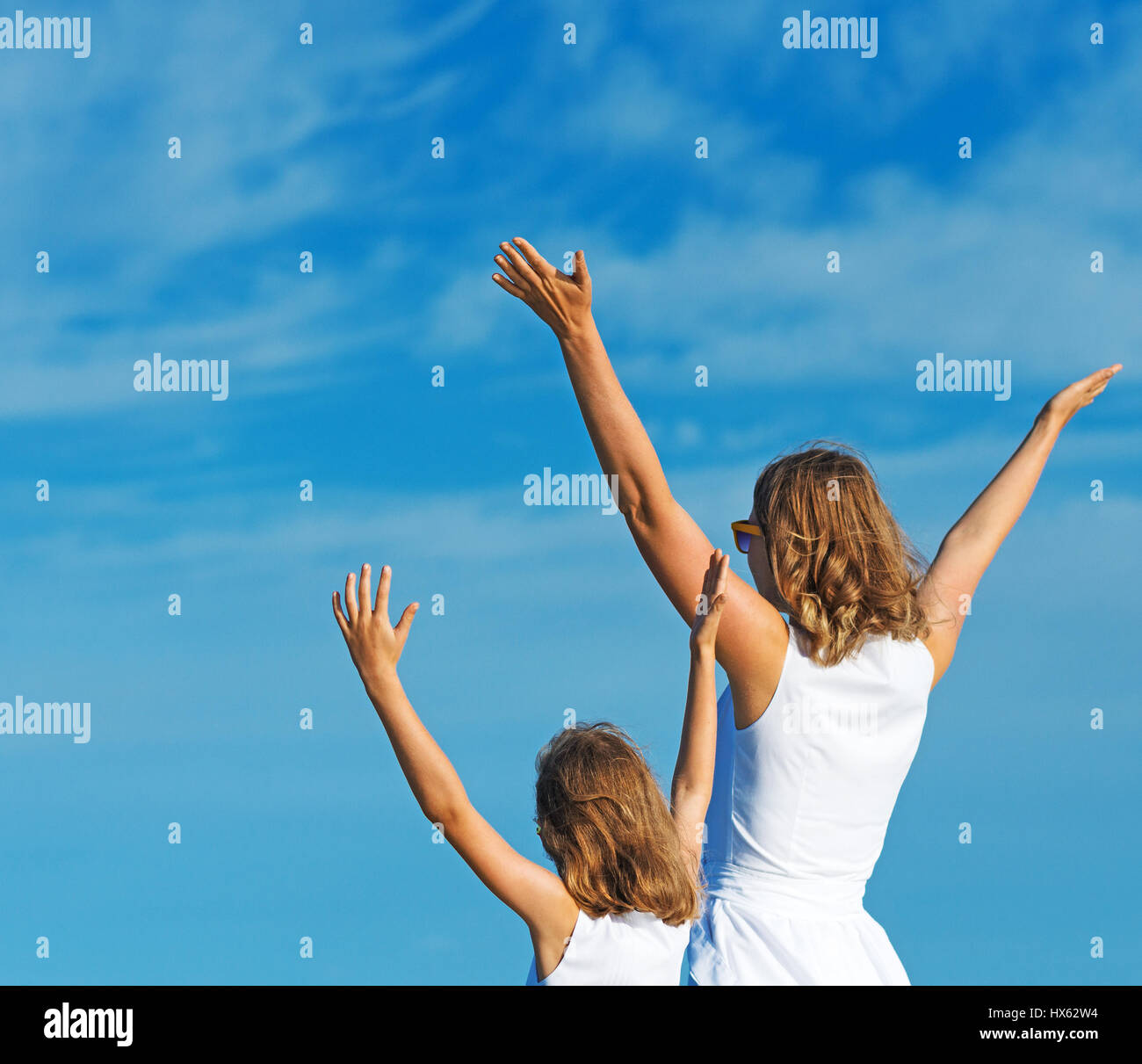 Woman arms raised rear view sky hi-res stock photography and images - Alamy