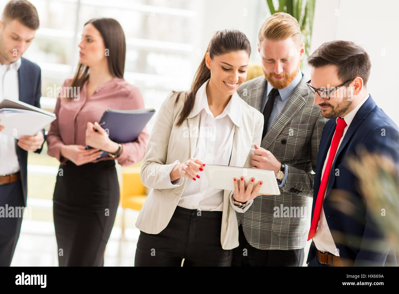 Group of businesspeople standing in the modern office Stock Photo - Alamy