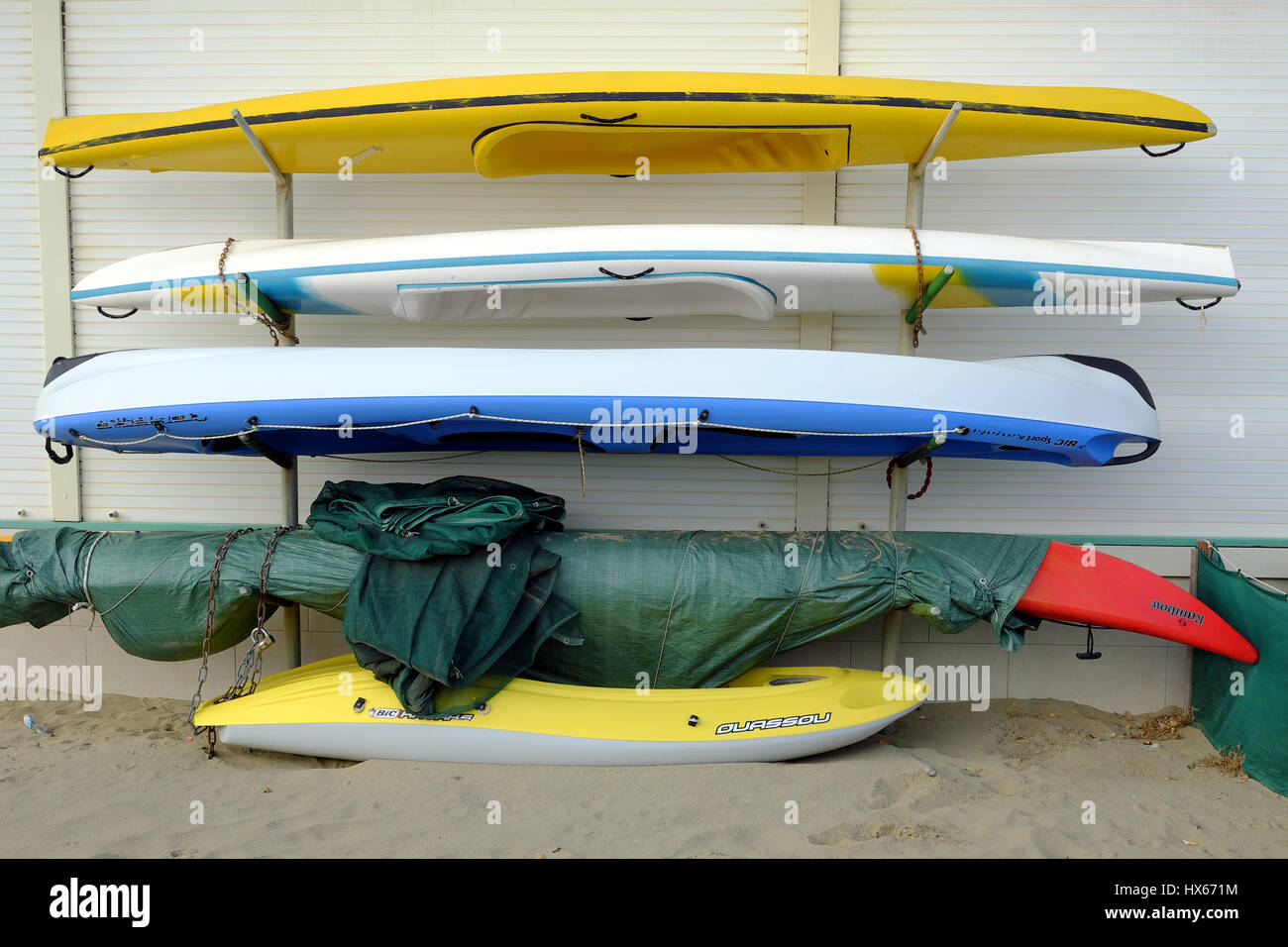 Sea kayak canoes stacked on racks Beach club marina in Viareggio