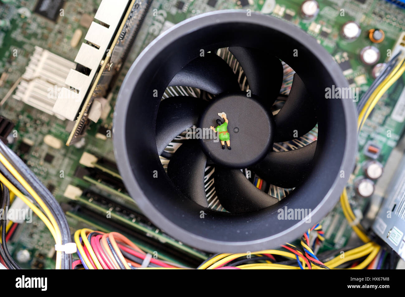 A tiny 00 gauge miniature model cleaner shown cleaninge internal processor heat  sink fan of a dirty computer Stock Photo - Alamy