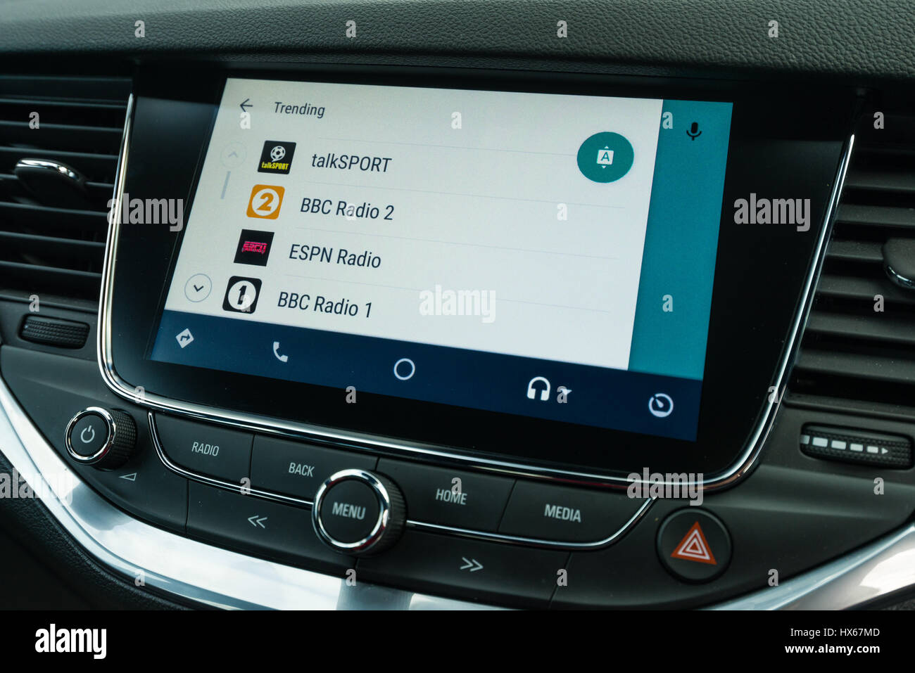Android Auto Car Vehicle Navigation Interface Showing TuneIn App List Stock Photo