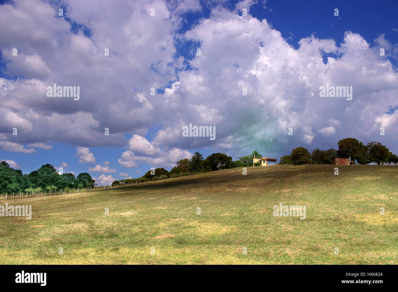 A country scene and a farmhouse in a cloudy day Stock Photo