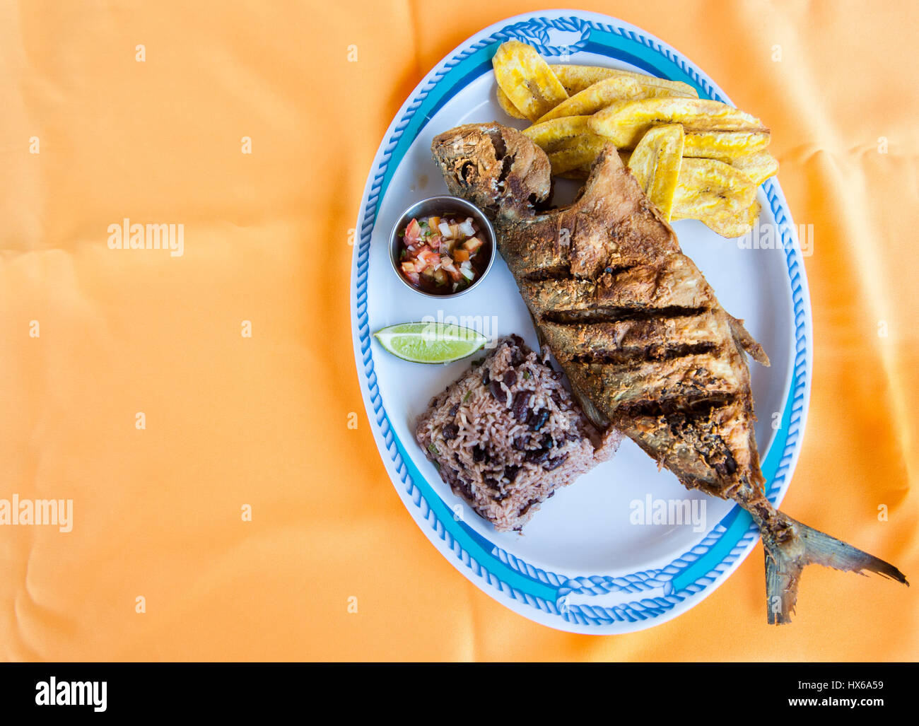 Whole Fish, Rice with Beans and Plantain Chips Stock Photo Alamy