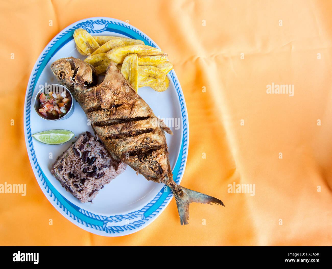 Whole Fish, Rice with Beans and Plantain Chips Stock Photo Alamy