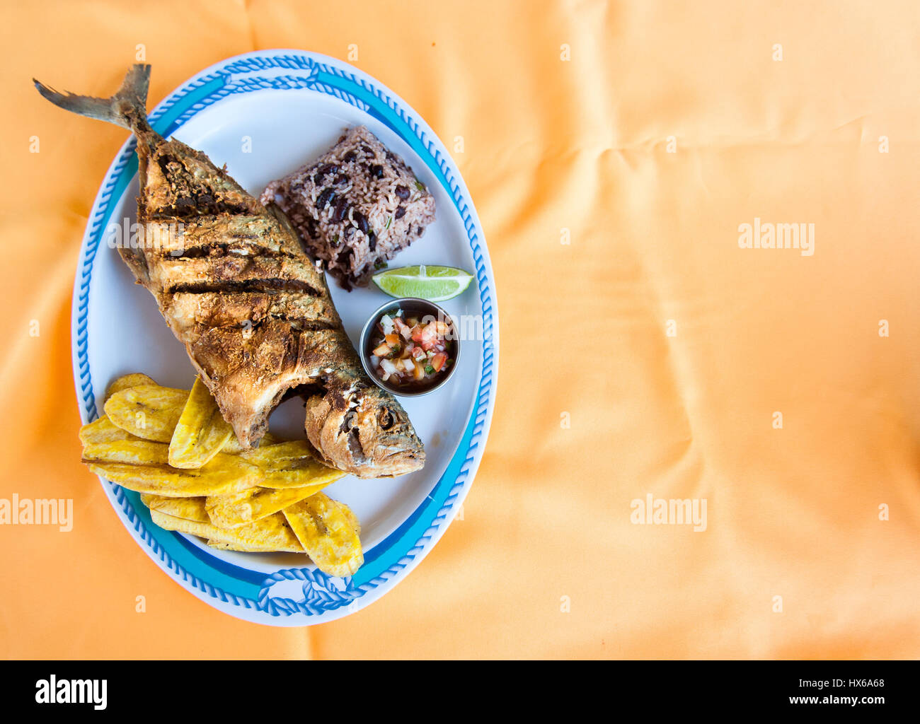 Whole Fish, Rice with Beans and Plantain Chips Stock Photo Alamy