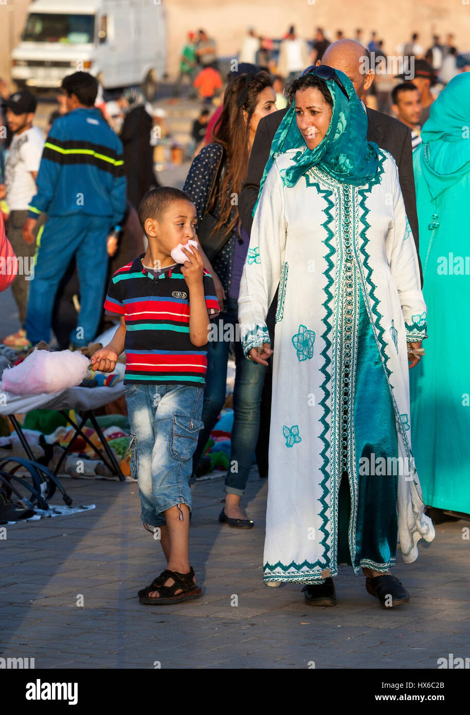 Meknes, Morocco.  Mother and Son Walking in the Place Hedime, Boy Eating Cotton Candy. Stock Photo