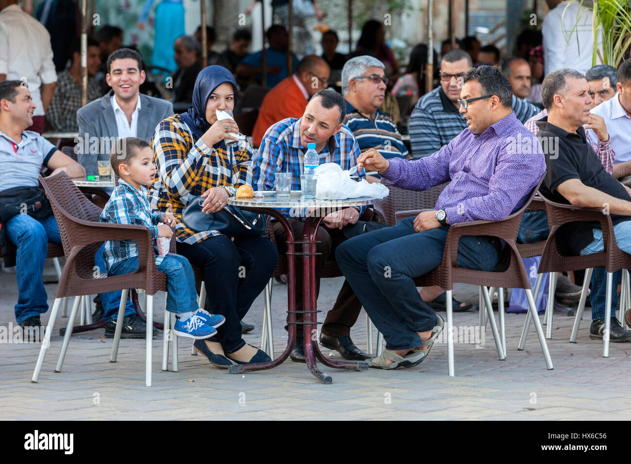 Meknes, Morocco.  Family Easting at a Cafe in the Place Hedime. Stock Photo