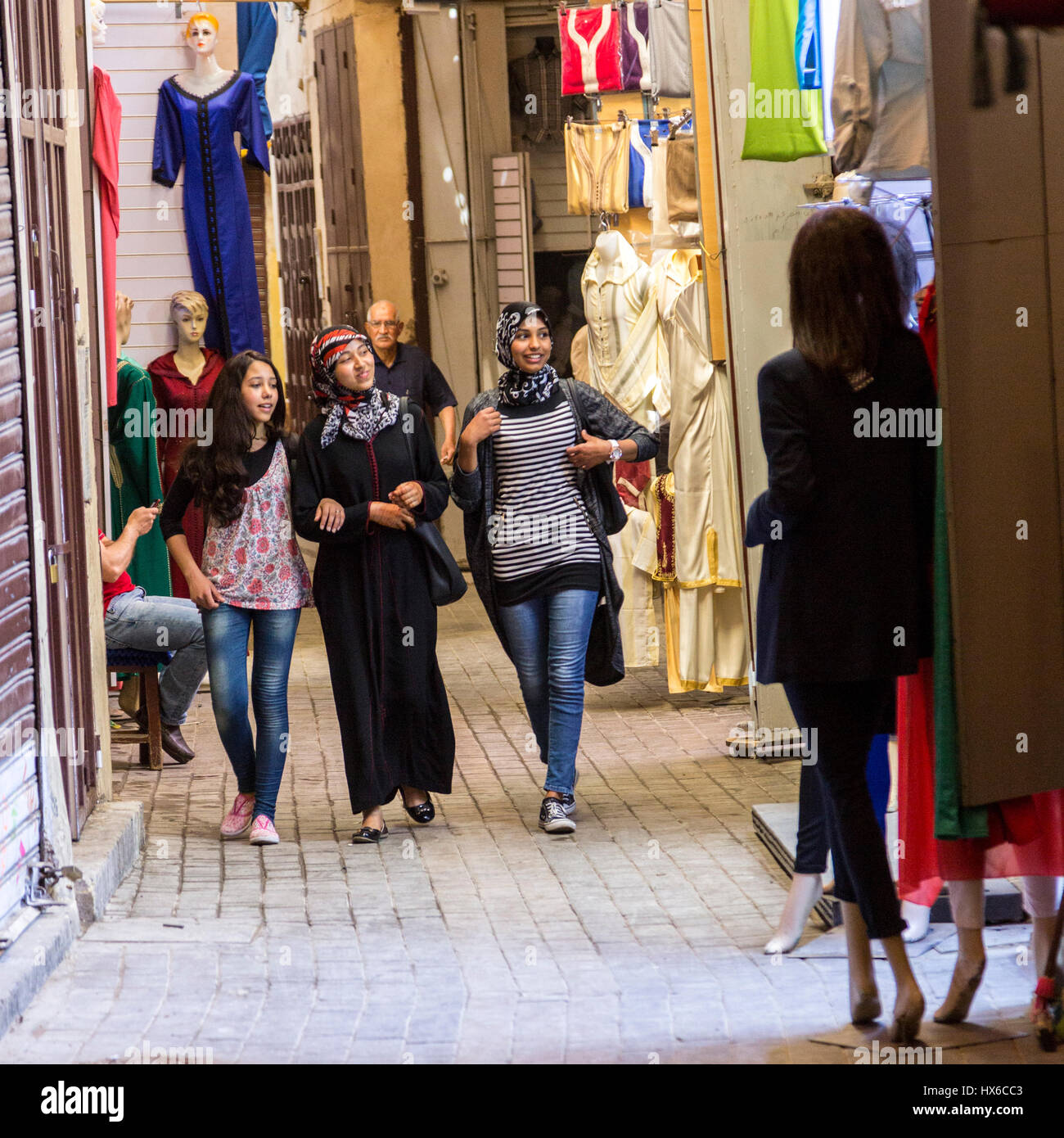 Meknes, Morocco.  Young Moroccan Women in Casual Modern Dress Walking in the Market in the Medina. Stock Photo