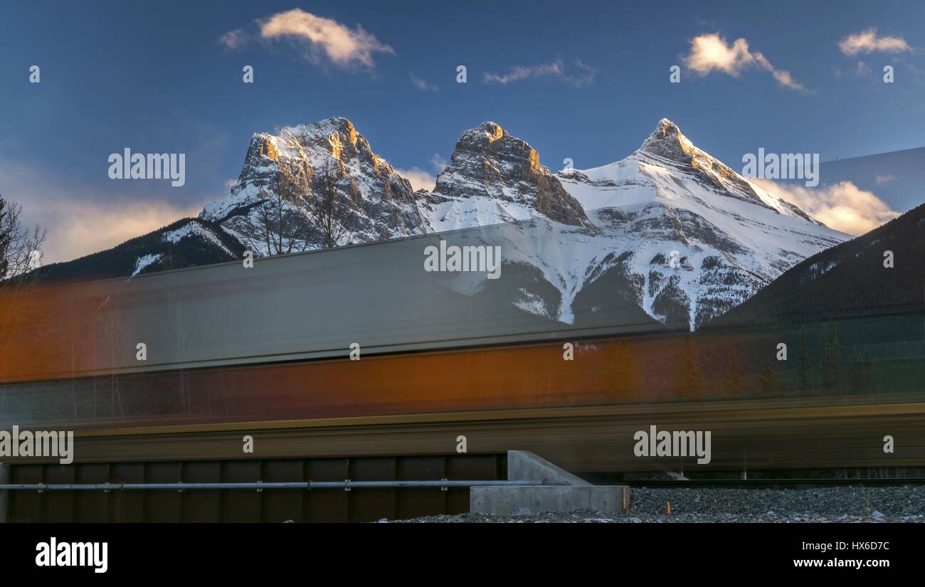 Scenic Blurred Transparent View High Speed Moving Canadian Pacific Train Bow Valley Canmore Alberta Landscape with Three Sisters Mountain on Skyline Stock Photo