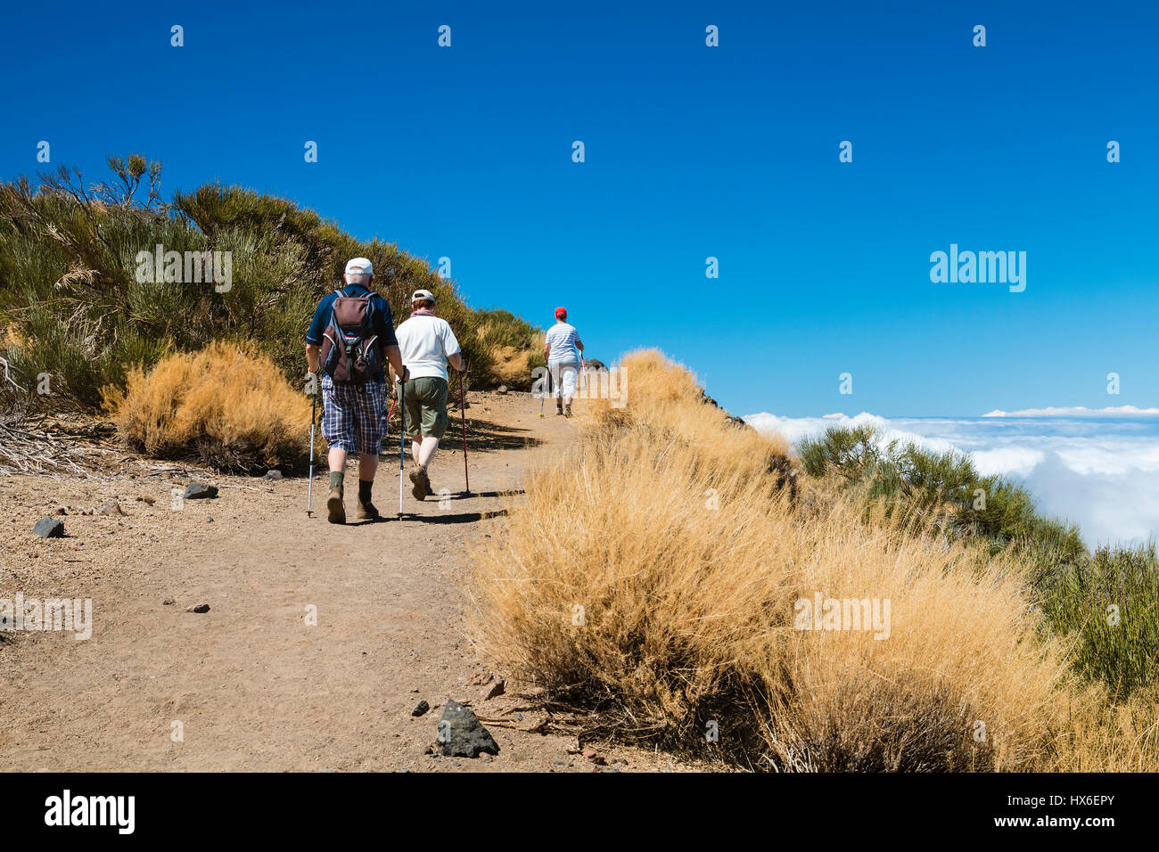 TENERIFE - OCTOBER 6: Senior tourists hiking on the Montana de las Arenas Negras above the clouds in Tenerife, Spain on October 6, 2014 Stock Photo
