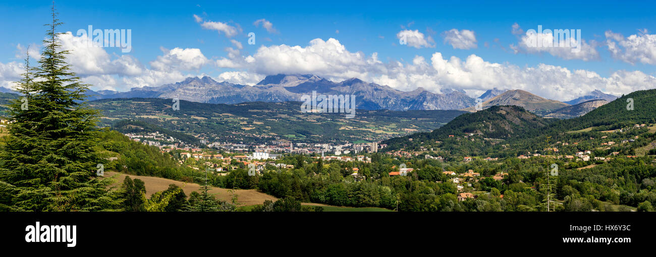 The city of Gap in the Hautes Alpes with surrounding mountains and peaks in Summer. Panoramic. Southern French Alps, France Stock Photo