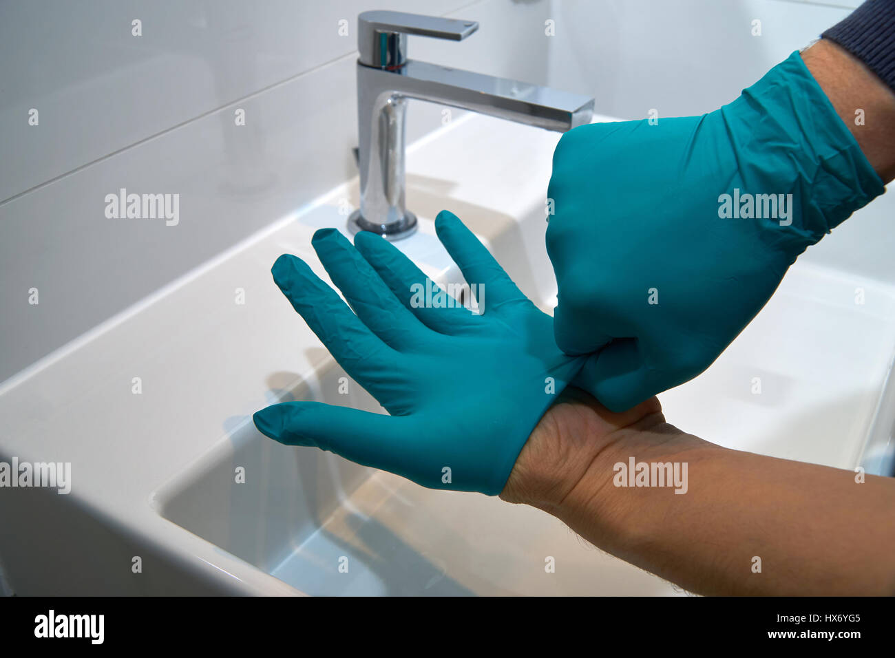 putting on medical gloves, close up Stock Photo