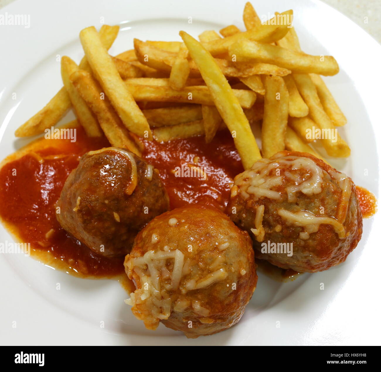Homemade meatballs in sauce served with fries Stock Photo