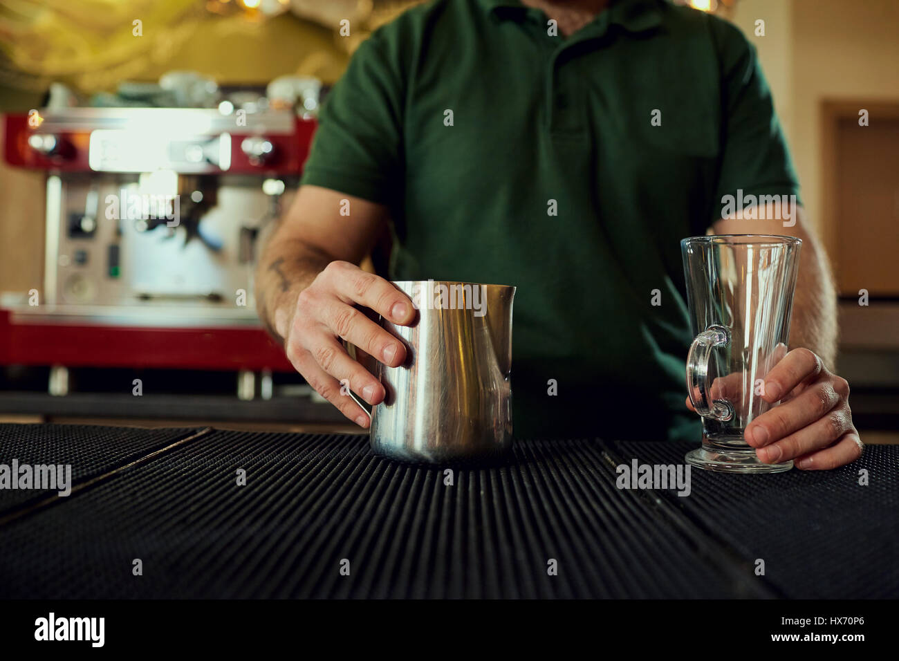 The bartender barista with a glass in bar cafe restaurant Stock Photo