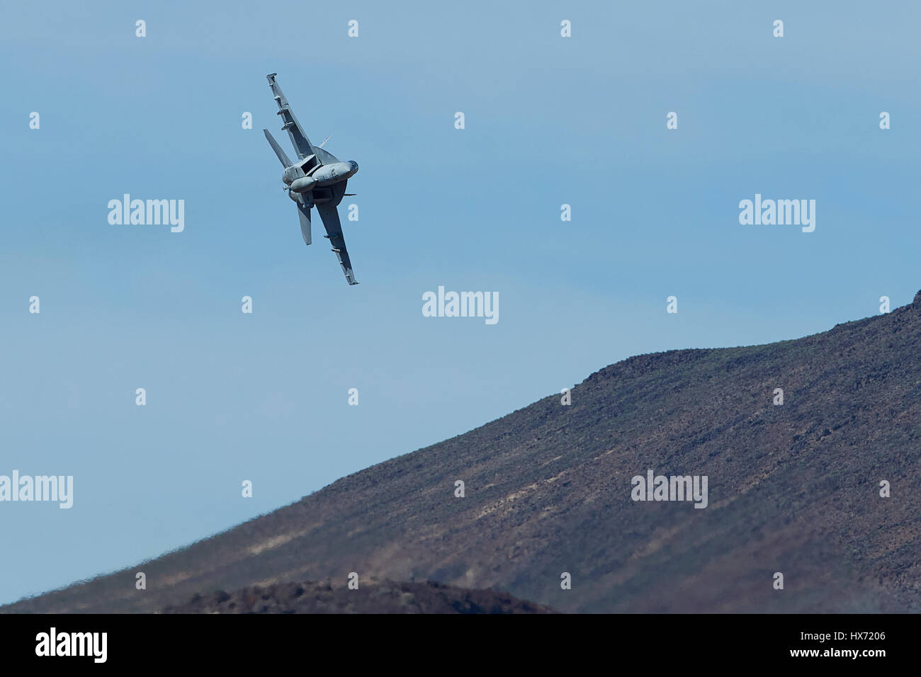 United States Navy F/A-18F Super Hornet Flying At Low Level Through A Desert Canyon. Stock Photo