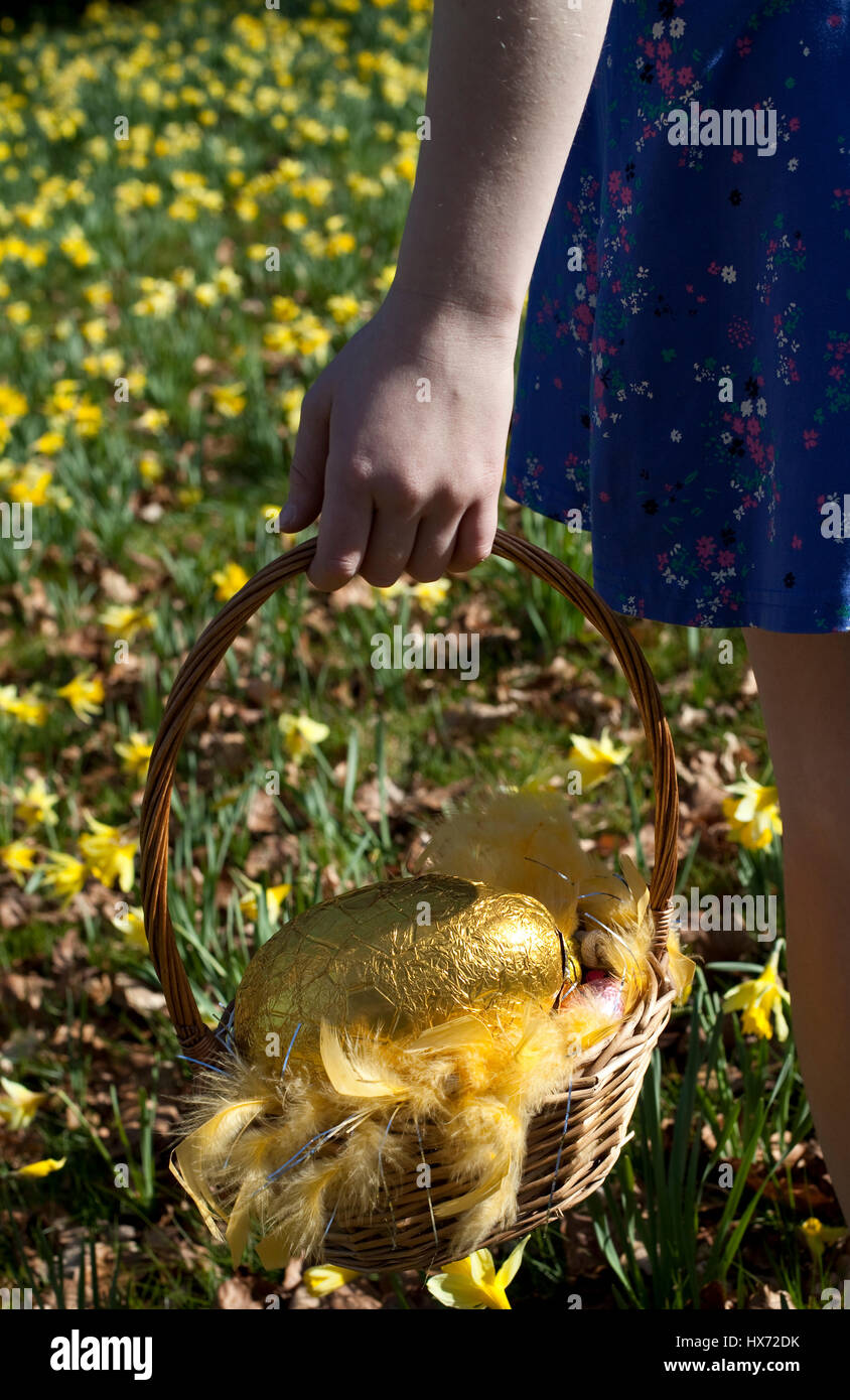 Girl with Easter bonnet on an Easter egg hunt in Lancashire, UK Stock Photo