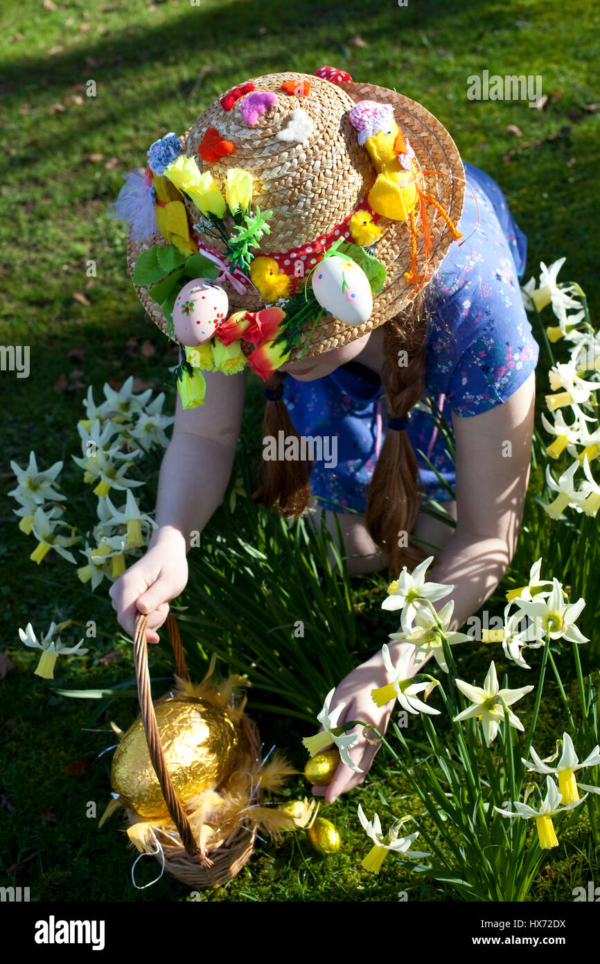 Girl with Easter bonnet on an Easter egg hunt in Lancashire, UK Stock Photo